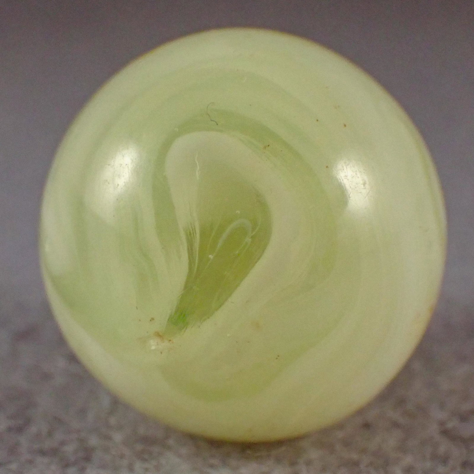 MARBLES. AKRO AGATE COMPANY, Slag. 7/8". Near Mint: AKRO AGATE COMPANY, Slag. Very fluorescent yellow slag. Has a small subsurface moon, one small flake, a couple tiny flakes. The glass on the yellow ones is very soft and it is very difficult to find s