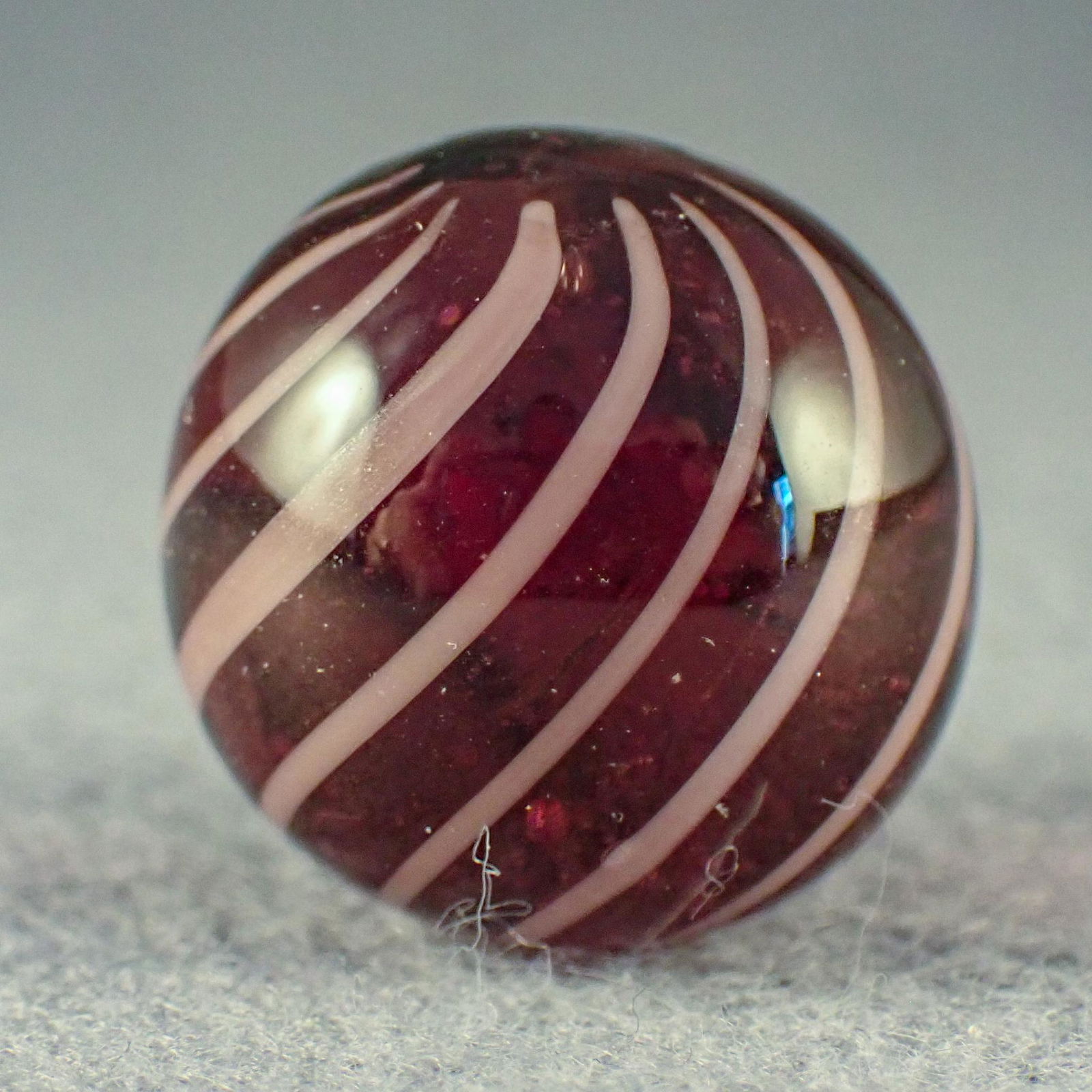 Marbles. CONTEMPORARY HANDMADE, Dale Danowski. 27/32".: CONTEMPORARY HANDMADE, Dale Danowski. Amethyst base Gooseberry Swirl. Signed with the Dale Danowski logo of "DD" in a yin yang pattern. Late 1990s. 27/32". Mint (9.9).