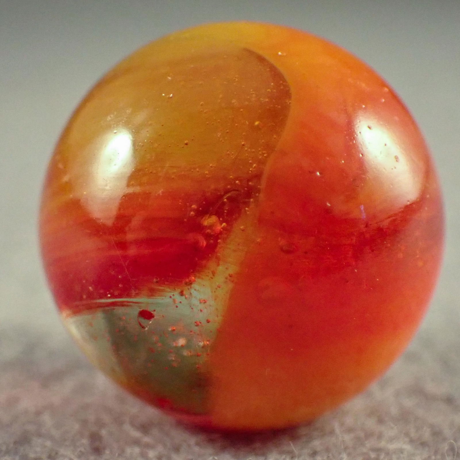 Marbles. PELTIER GLASS COMPANY. Rainbo. Windshield.: PELTIER GLASS COMPANY, Rainbo. Hard to find Rainbo Windshield. A type of clear Rainbo. Bubble filled clear base with opaque yellow and translucent red wide ribbons on the surface. Ottawa IL, circa 193