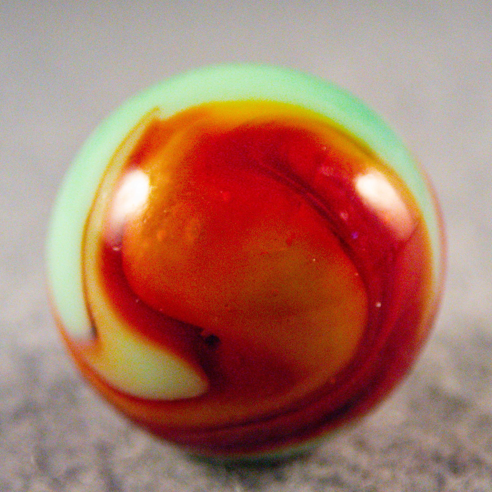 Marbles. PELTIER GLASS COMPANY, National Line Rainbo. 23/32". Mint (9.9).: PELTIER GLASS COMPANY, National Line Rainbo. Four-ribbon two-color National Line Rainbo. Four wide translucent red ribbons in green. Ottawa IL, circa 1925-1935. 23/32". Mint (9.9).