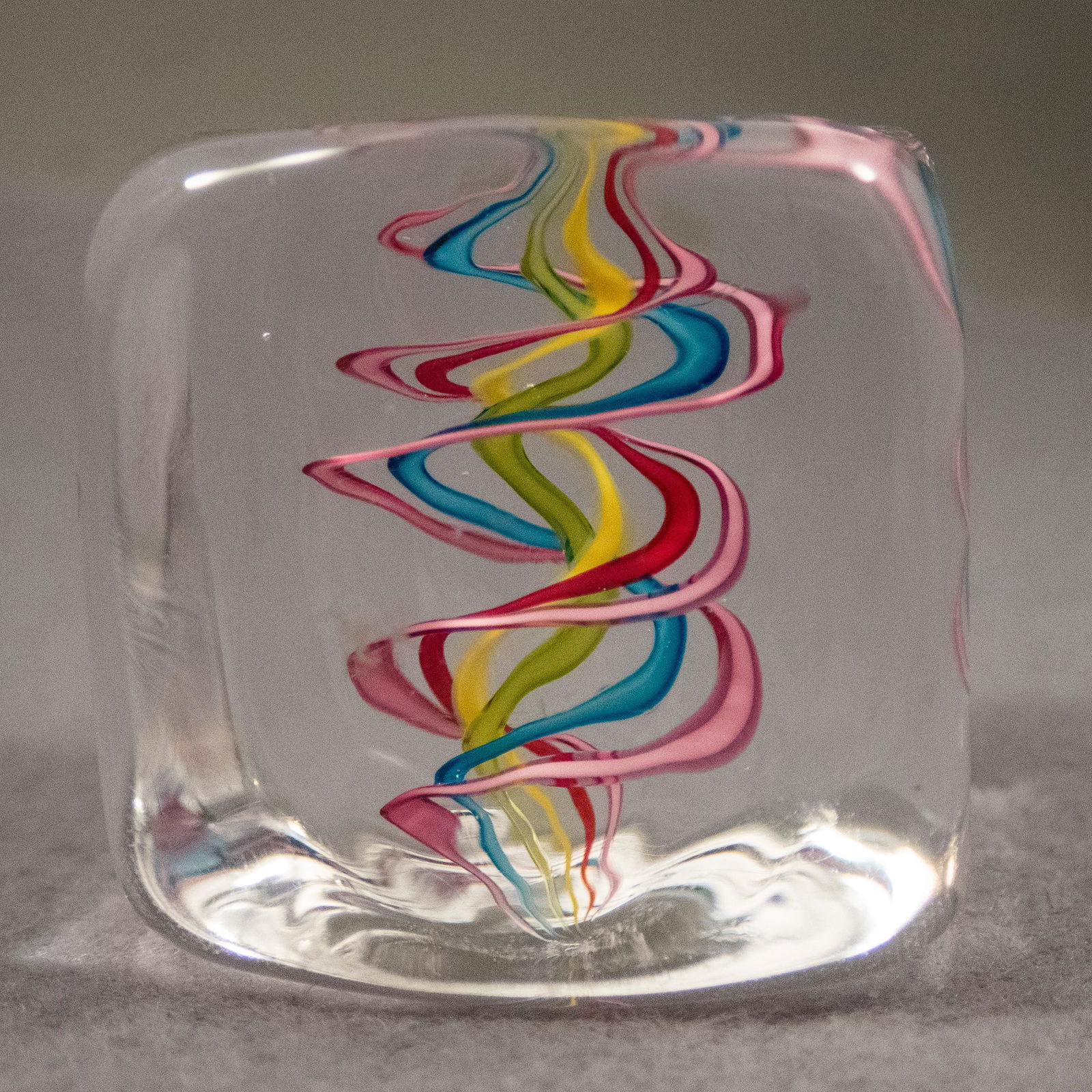 Marbles: CONTEMPORARY HANDMADE, Nicholas Kekic. 1-3/8". Mint (9.9).: CONTEMPORARY HANDMADE, Nicholas Kekic. A "Squarble". Clear glass cube with a ribbon core. Signed "N. Kekic". 1-3/8". Mint (9.9).