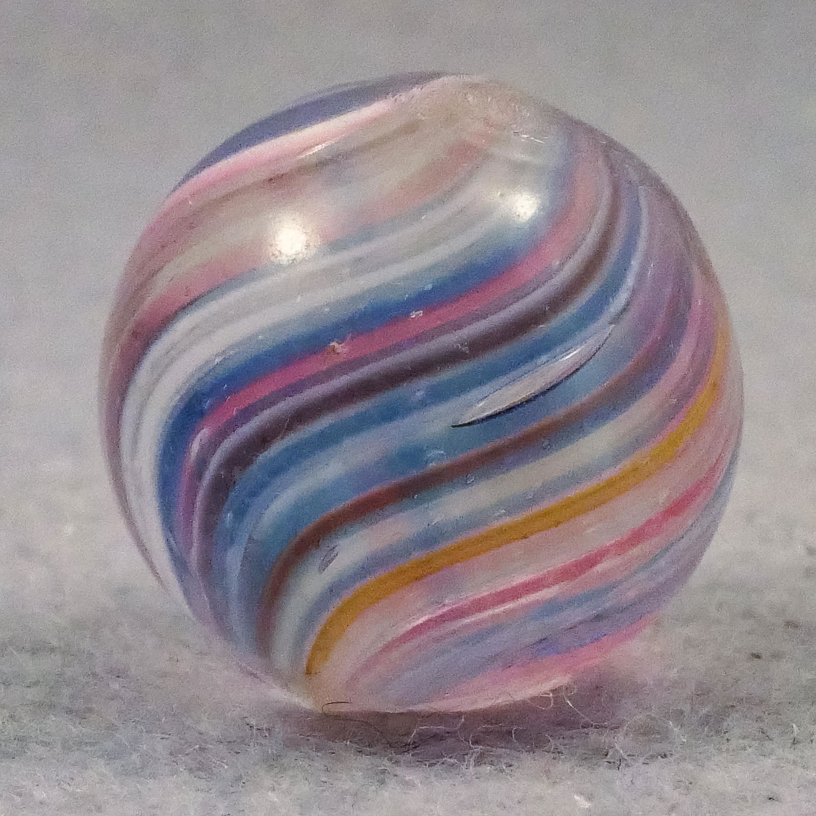 Marbles: END OF DAY, Joseph Coat. 11/16". Mint (9.9).: END OF DAY, Joseph Coat. Clear base. Subsurface layer is packed bands of opaque white, translucent pink and translucent blue, with clear spaces. Germany, circa 1860-1920.11/16". Mint (9.9).