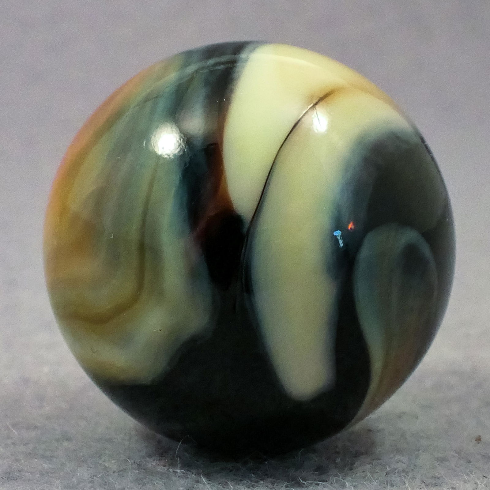 Marbles: PELTIER GLASS COMPANY, Nova. 15/16". Mint (9.9).: PELTIER GLASS COMPANY, Nova. Black base. One coral on ivory patch and one ivory patch. Short run made in 1988. Ottawa IL, circa 1988.15/16". Mint (9.9).