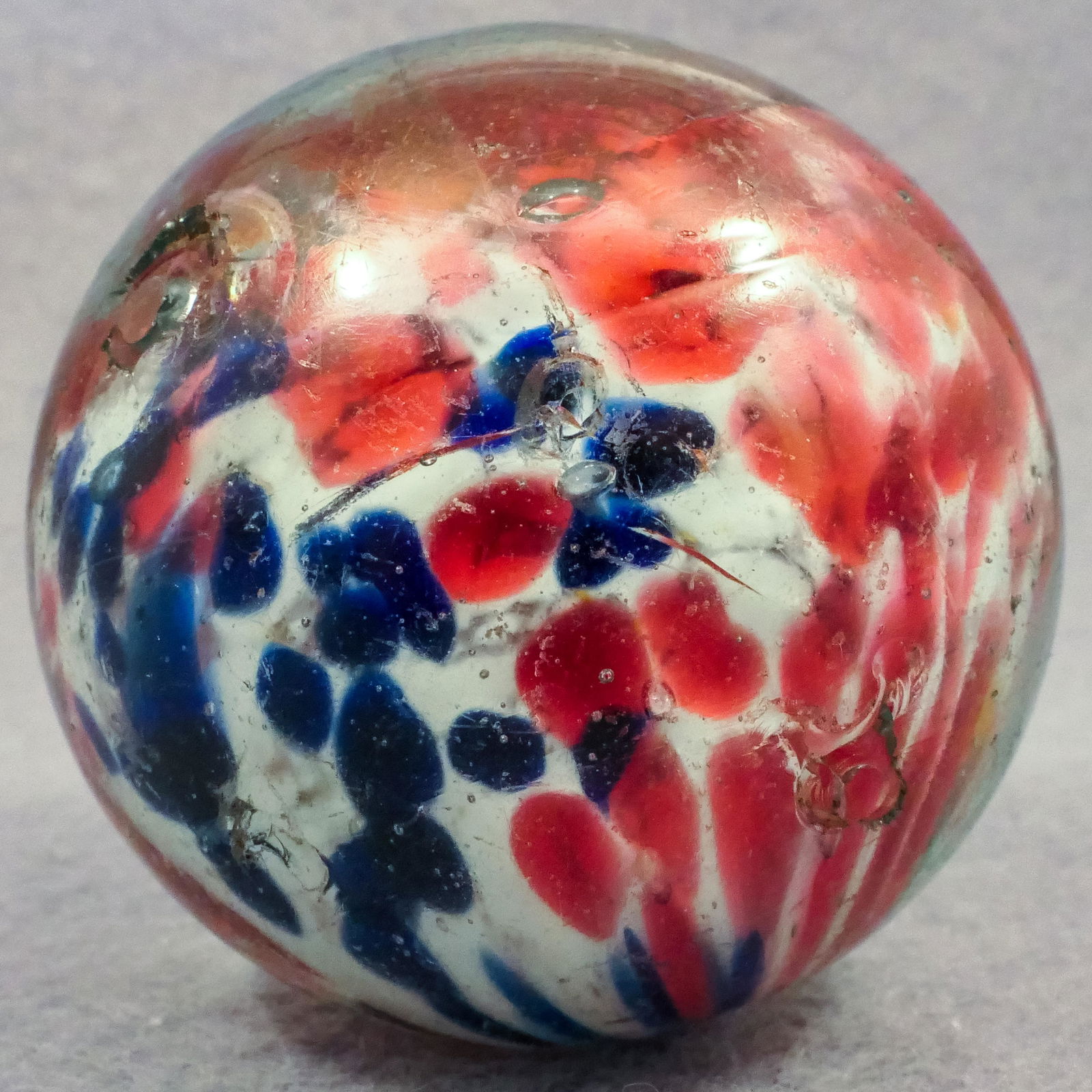 Marbles: END OF DAY, Cloud. 1-3/4". Near Mint(-) (8.0).: END OF DAY, Cloud. Very rare two-panel single pontil Cloud. Opaque white core that does not rise to the top. Pink splotches on most of the core with one panel of blue splotches. Slightly shrunken on t