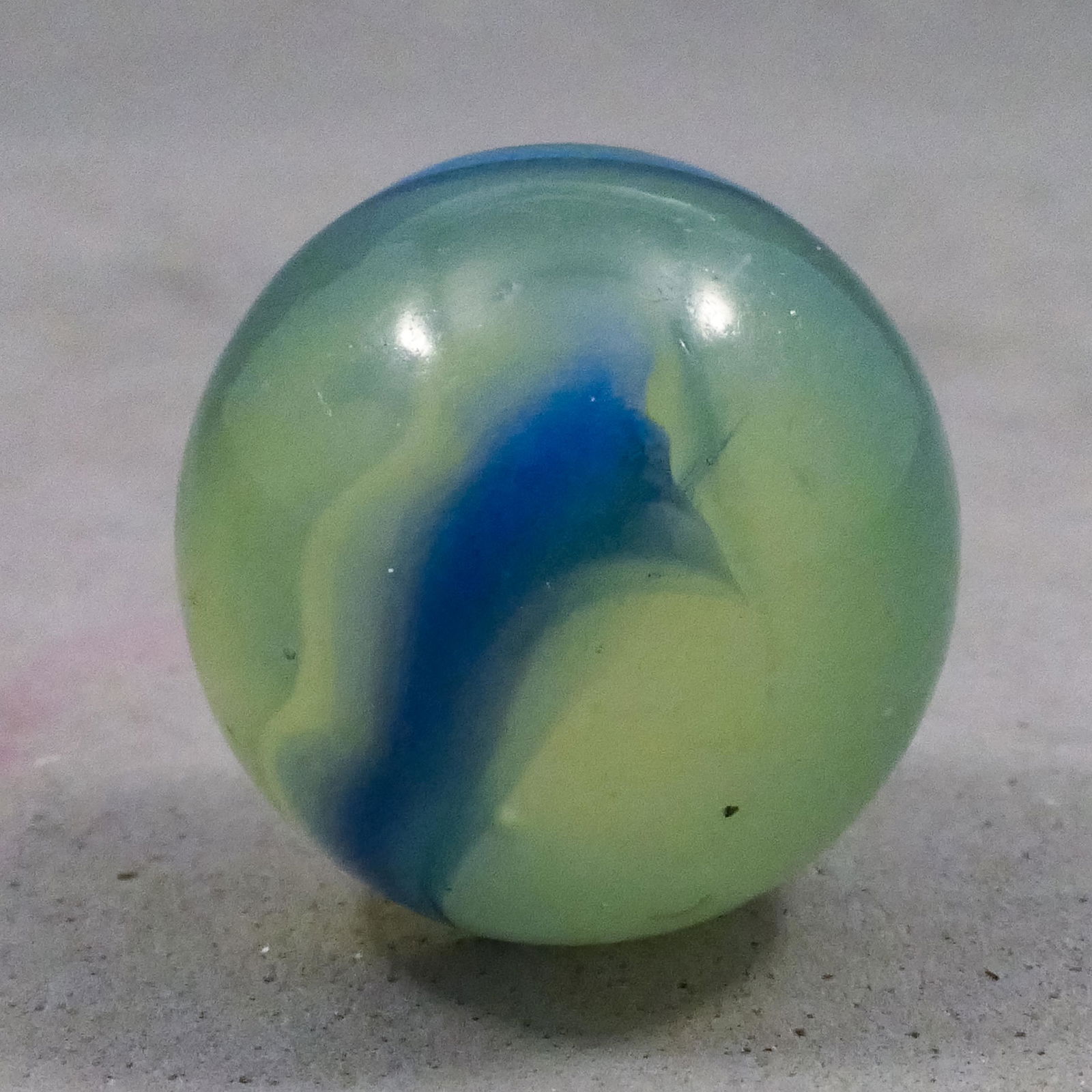 Marbles: AKRO AGATE COMPANY, BlueberryAde. 21/32". Near Mint(+) (8.9).: AKRO AGATE COMPANY, Ade. Rare BlueAde or BlueberryAde. Fluorescent ade base. Light blue opaque spiral on the marble. The spiral is edged by transparent dark blue. Rare. Has a tiny subsurface moon. Cla