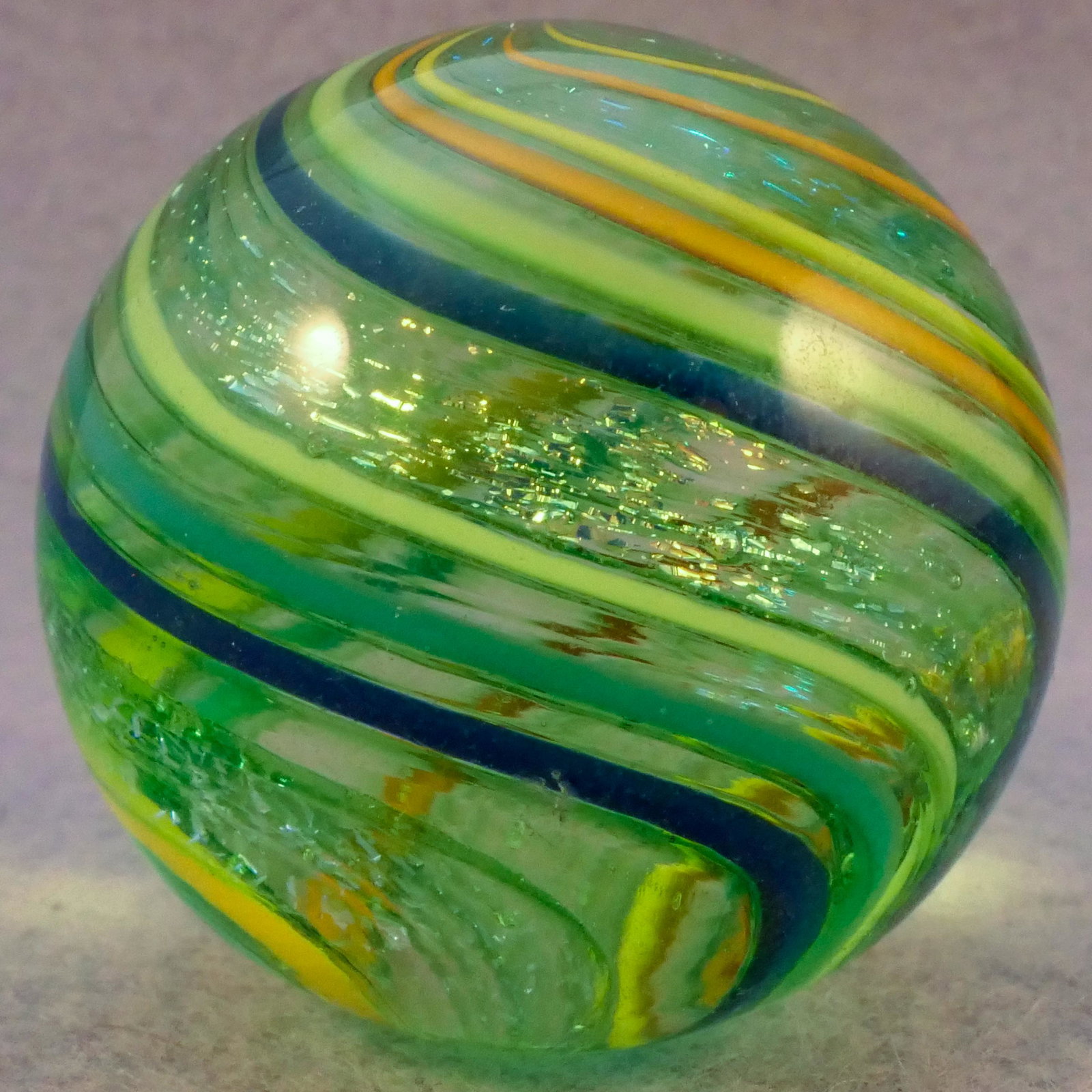 Marbles: CONTEMPORARY HANDMADE. 1-5/16". Near Mint(+) (8.9).: CONTEMPORARY HANDMADE. Nice swirl with dichroic bands. Small subsurface moon. Unsigned, unidentified artist. 1-5/16". Near Mint(+) (8.9).