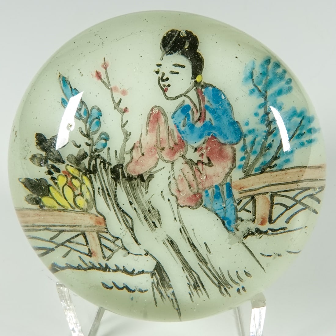 PAPERWEIGHT, Chinese. Chinese White.: PAPERWEIGHT, Chinese. Beautiful "Chinese White" paperweight. Clear base. White background glass-painted with a woman in a garden. China, circa 1915-1935. Width: 2-3/8". Height: 1-7/8". Mint.