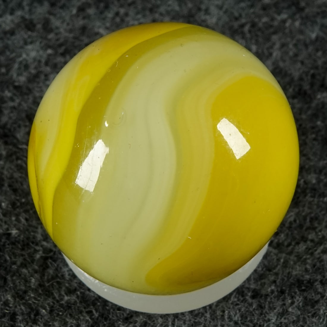 AKRO AGATE COMPANY, Lemonade. 27/32". Mint (9.9).: AKRO AGATE COMPANY, Lemonade. Fluorescent Ade base with semi-opaque yellow swirls and wispy semi-opaque white swirls. Clarksburg WV, circa 1925-1935. 27/32". Mint (9.9).