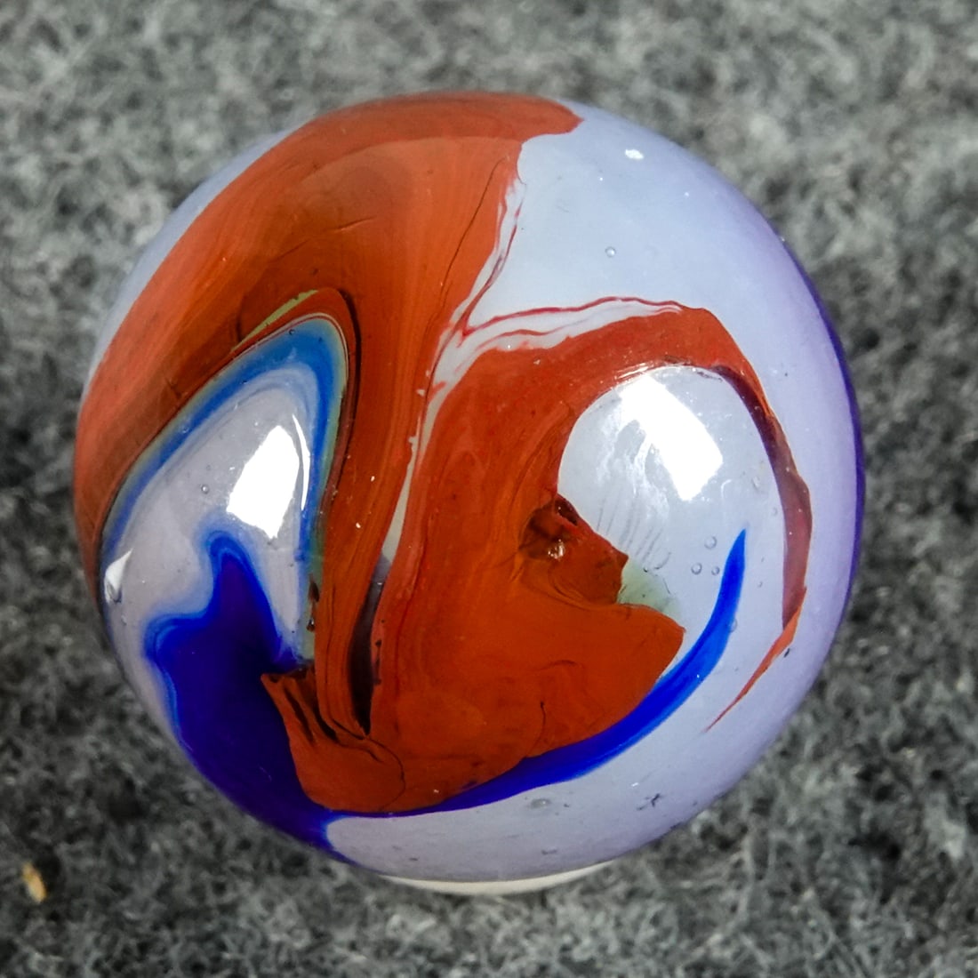 AKRO AGATE COMPANY, Blue Oxblood. 21/32". Mint (9.9).: AKRO AGATE COMPANY, Blue Oxblood. Semi-opaque milky base. Opaque blue and wide oxblood swirls. Clarksburg WV, circa 1925-1935. 21/32". Mint (9.9).