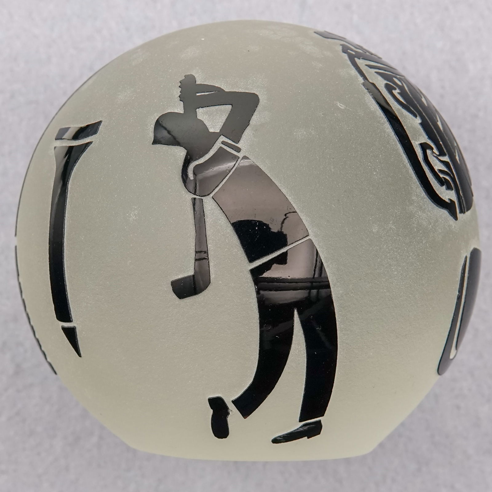 PAPERWEIGHT, Correia Art Glass. Golf motif.: PAPERWEIGHT, Correia Art Glass. Overlay weight cut to clear. The cameos are various golf motifs. Signed "Correia W08295 - 23-97-11". 3-1/8" width, 2-7/8" height. Mint. Circa 1997.