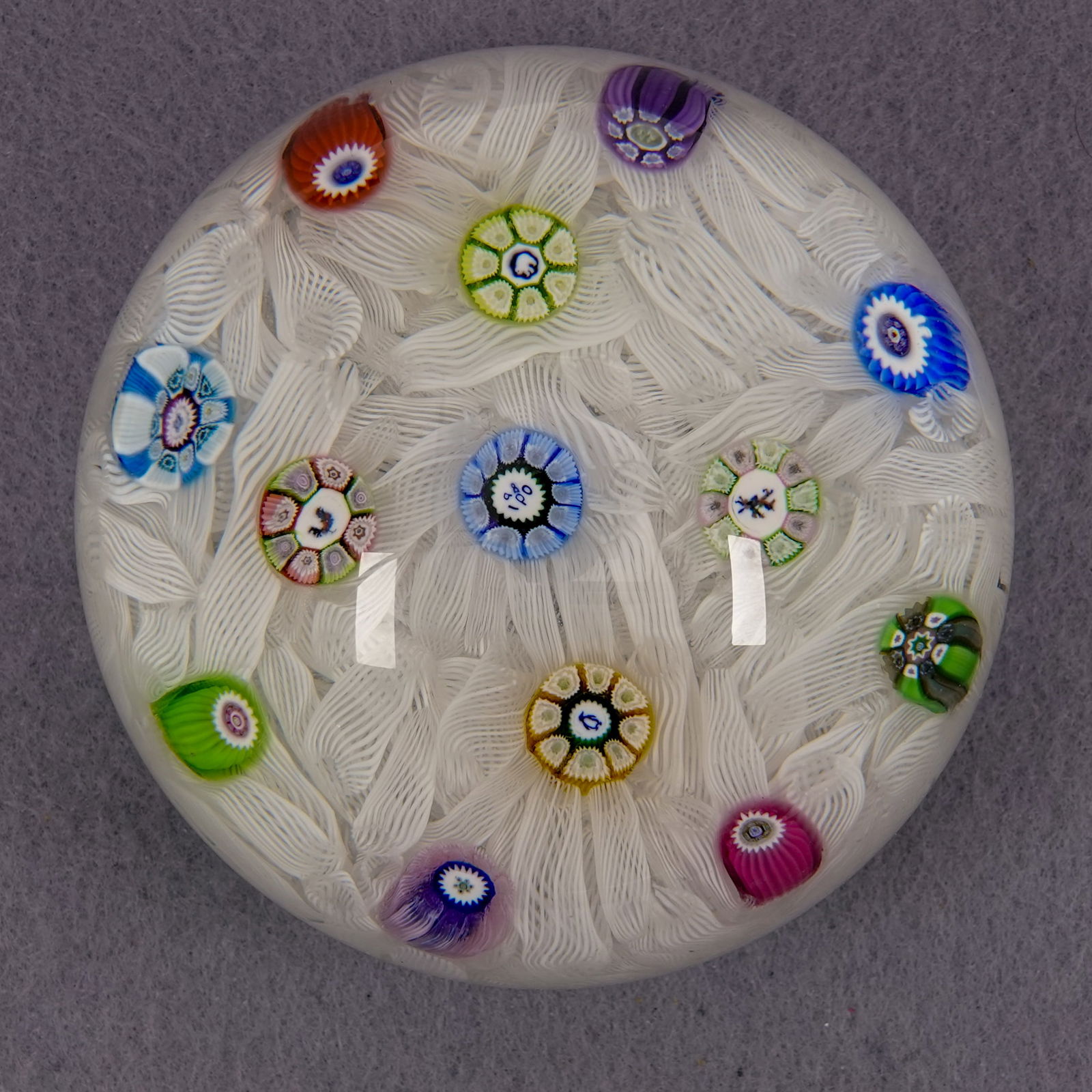 PAPERWEIGHT, Perthshire Paperweights. PP11.: PAPERWEIGHT, Perthshire Paperweights. Perthshire PP11. Contains 4 silhouette canes. Center cane is "P 1980". 2-3/4" width, 2-1/8" height. Mint.