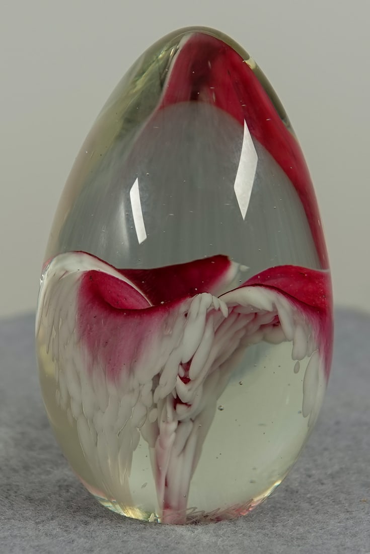 PAPERWEIGH. Signed "May".: PAPERWEIGHT, May. Floral paperweight. Signed "May 90". Consignor identified it as Glass Eye Studio. 1-5/8" width, 2-1/2" height. Mint.