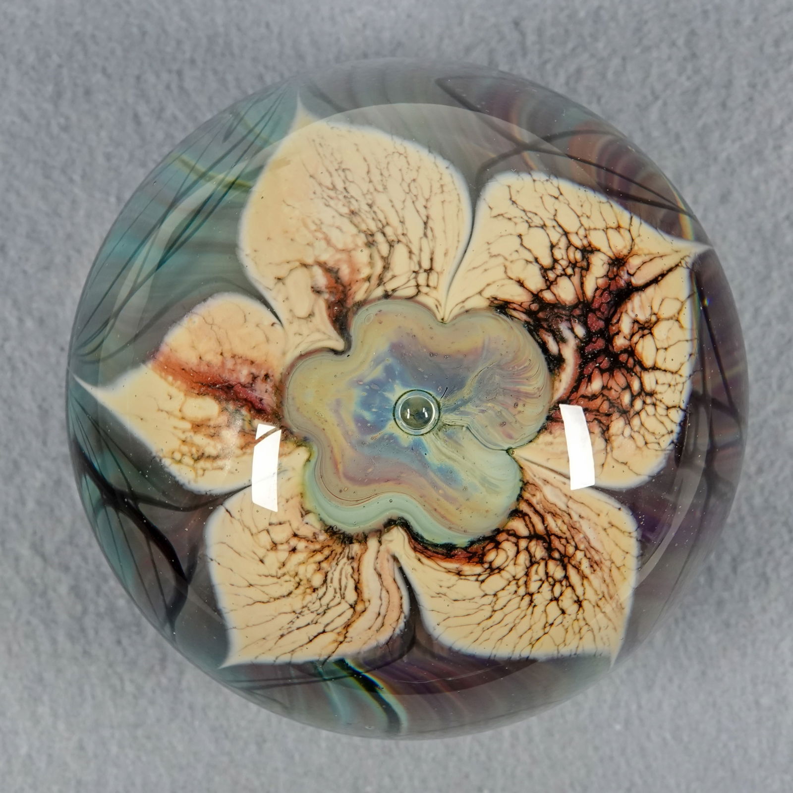 PAPERWEIGHT, Nichols Art Glass.: PAPERWEIGHT, Nichols Art Glass. Nice flower over blue/gray ground. Signed "Nichols". 3-1/8" width, 2-3/4" height.