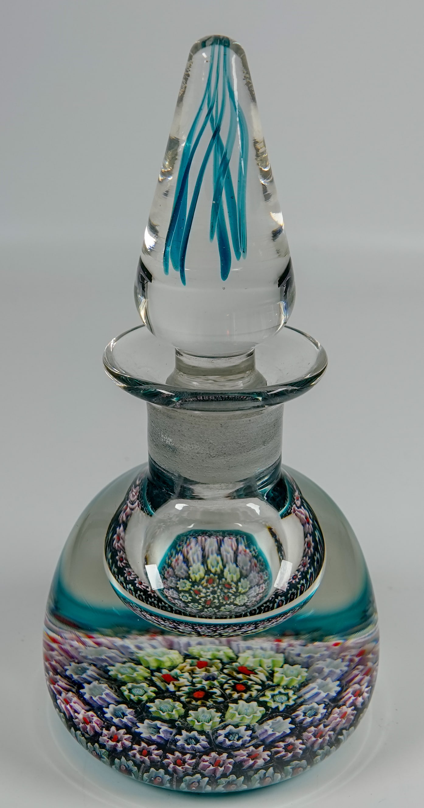 PAPERWEIGHT, Perthshire Paperweights. PP22. Scent Bottle.: PAPERWEIGHT, Perthshire Paperweights. Perthshire PP22 Scent Bottle. Nice concentric rings of millefiori in the base. Color threads in the stopper. Scotland, circa 1975-1990. 2-5/8" width, 5-1/4" heigh