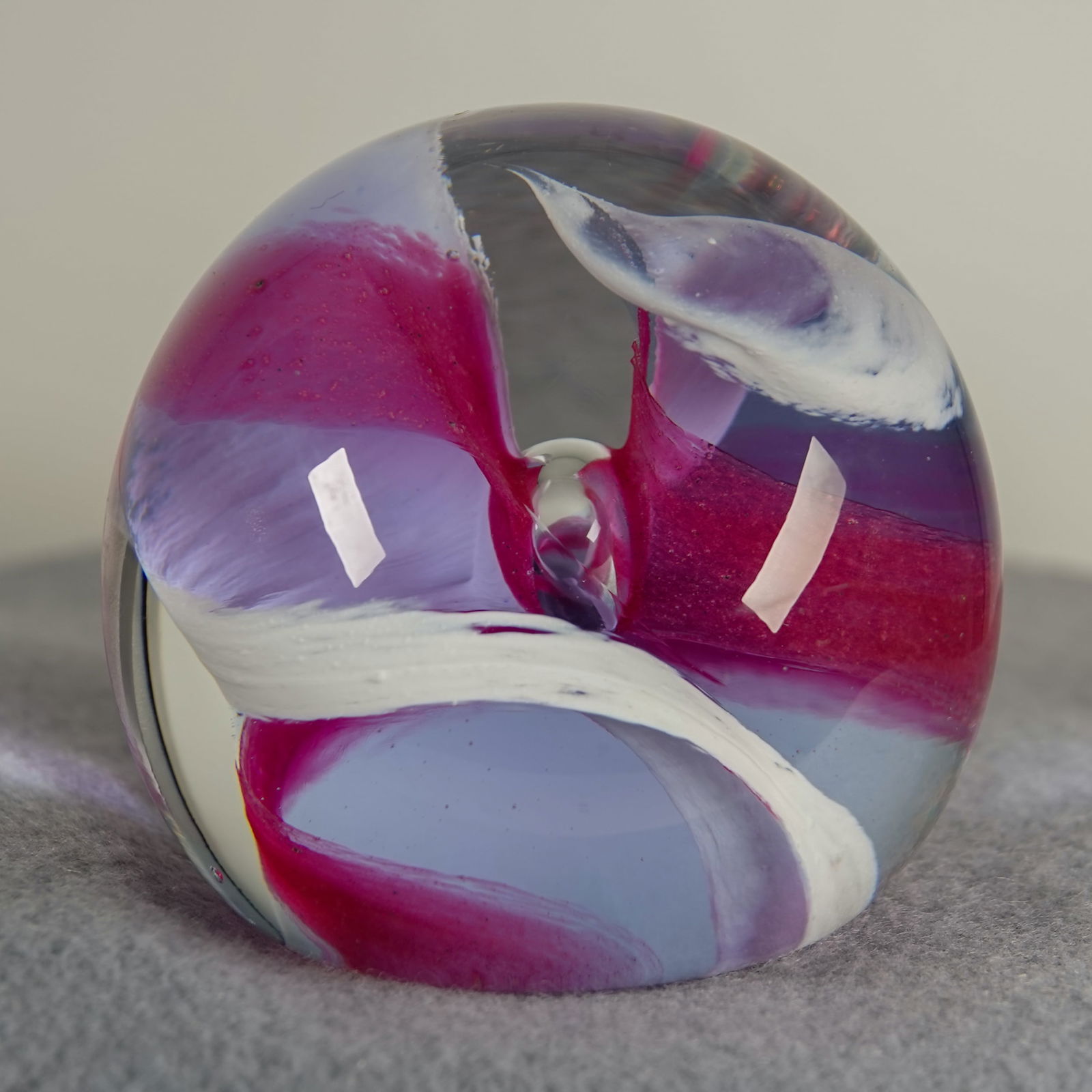 PAPERWEIGHT, Caithness Glass. Streamers.: PAPERWEIGHT, Caithness Glass. Caithness Streamers paperweight. Color ribbons in the core. Signed on bottom " H95186 Caithness Streamers Scotland". 2-1/2" width, 2-3/8" height. Mint.