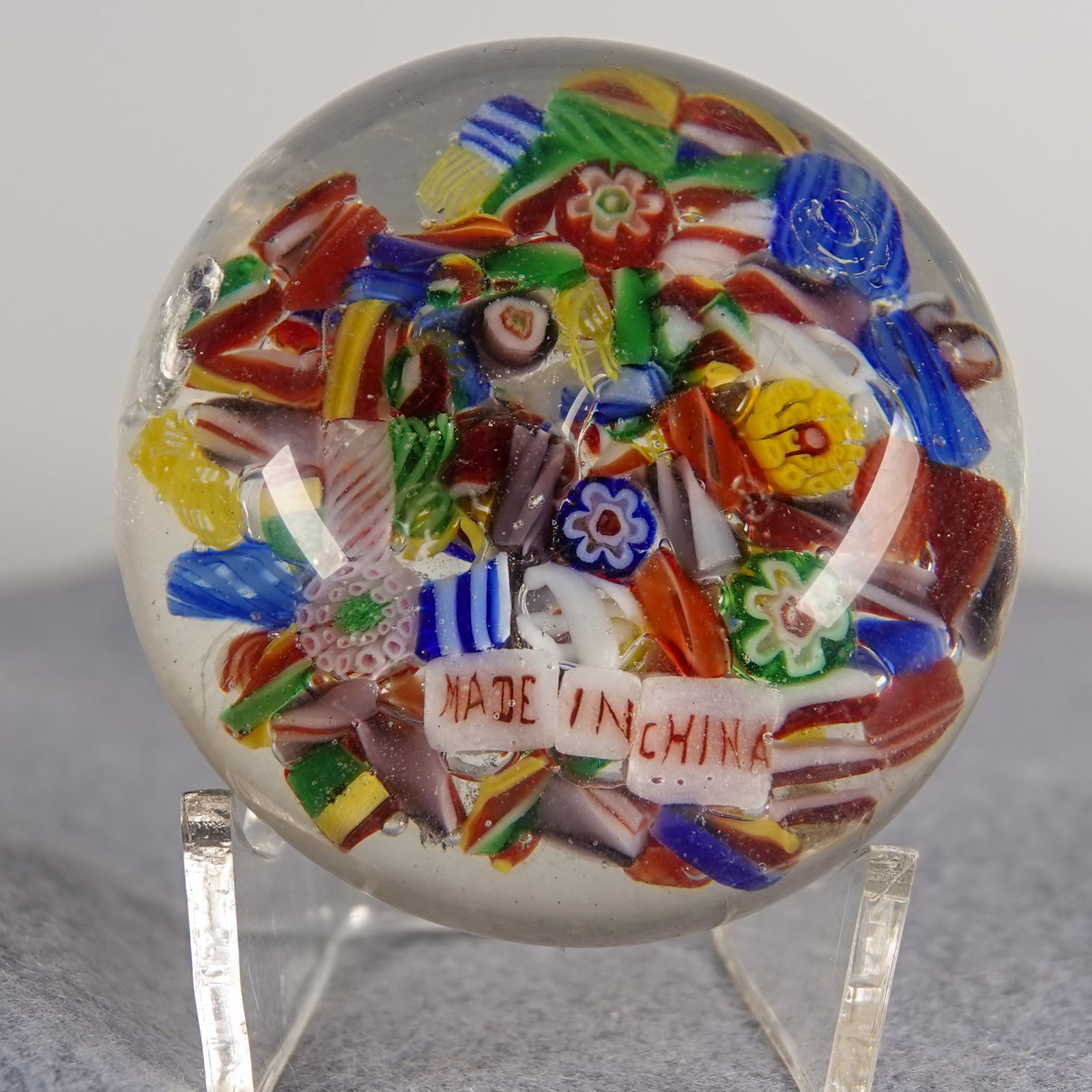 PAPERWEIGHT, Chinese. Antique.: PAPERWEIGHT, Chinese. Antique scramble weight with the "Made in China" canes inside. Small subsurface moon on the side. China, circa 1920-1935. 2-1/8" width, 1-3/8" height. Near Mint.