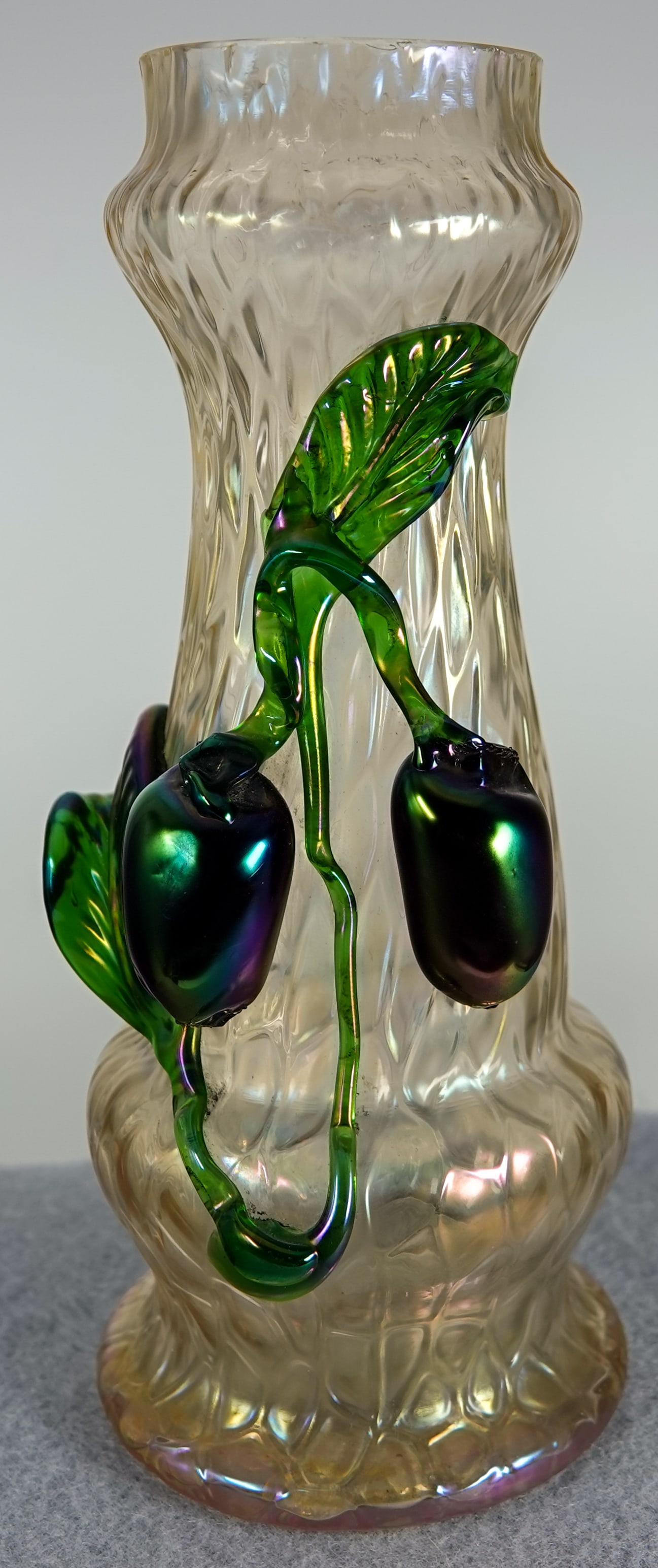 OTHER GLASS, Vase. Possibly Steven & Williams.: OTHER GLASS, Vase. Art Glass Vase. Vase with applied glass decoration. Vase is iridescent and has a Kralik-like pattern to it. The applied glass are plums and leaves. We are unsure of the age of this
