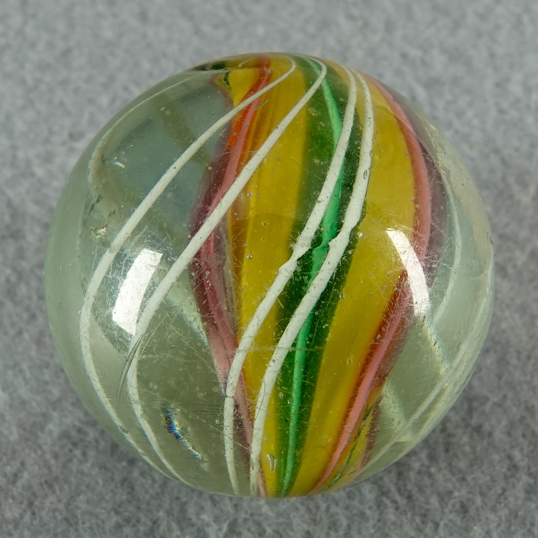 SWIRL, Solid Core. 1-3/8". Near Mint(+) (8.9).: SWIRL, Solid Core. Three-panel Solid Core. Each panel slightly lobed. A pit and a little light pocket wear. Germany, circa 1860-1920. 1-3/8". Near Mint(+) (8.9).