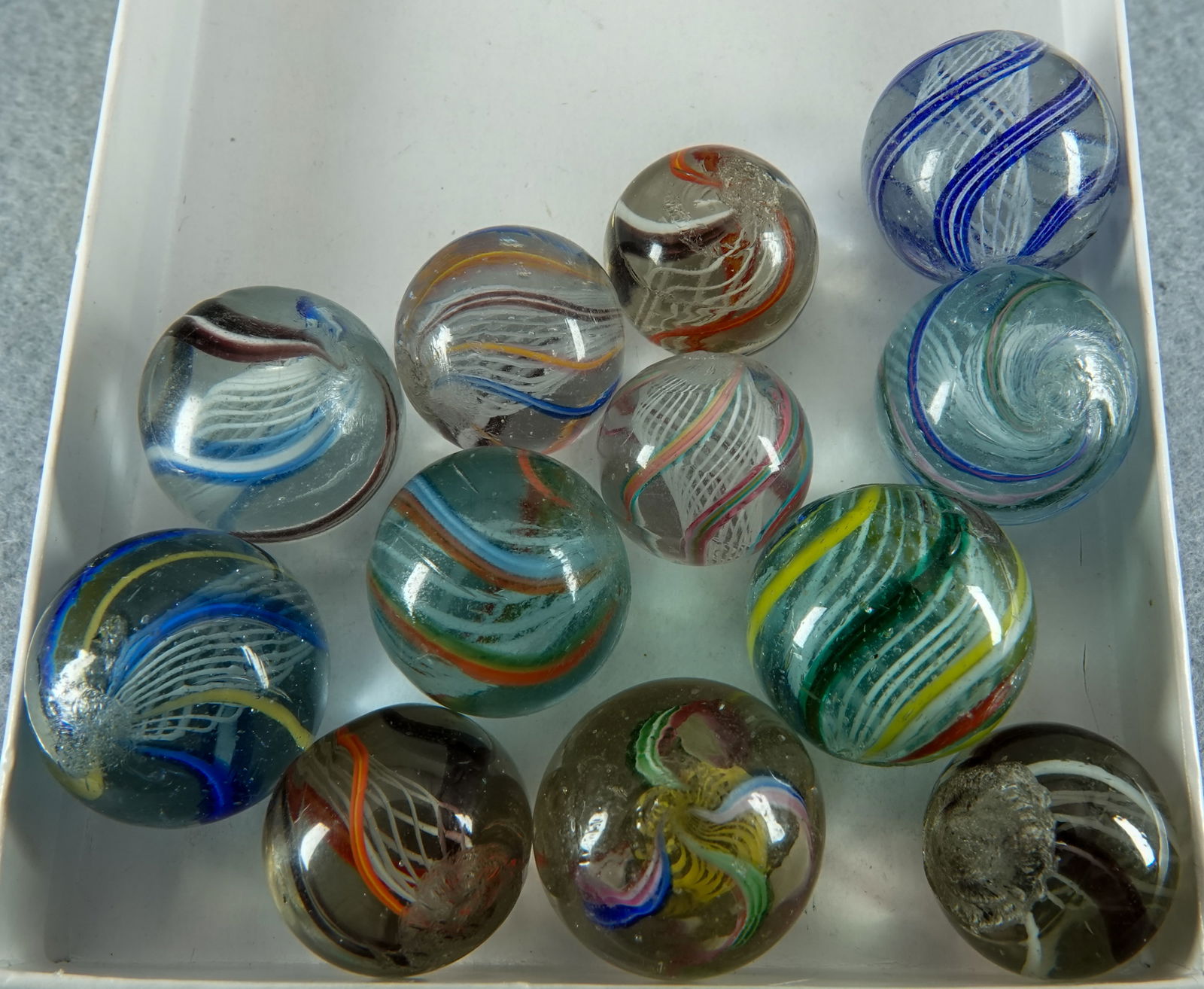 SWIRL, Latticinio Core. 12 marbles. All Mint.: SWIRL, Latticinio Core. Lot of twelve marbles. All are Latticinio Core. Germany, circa 1860-1920. 23/32" to 13/16". All are Mint.