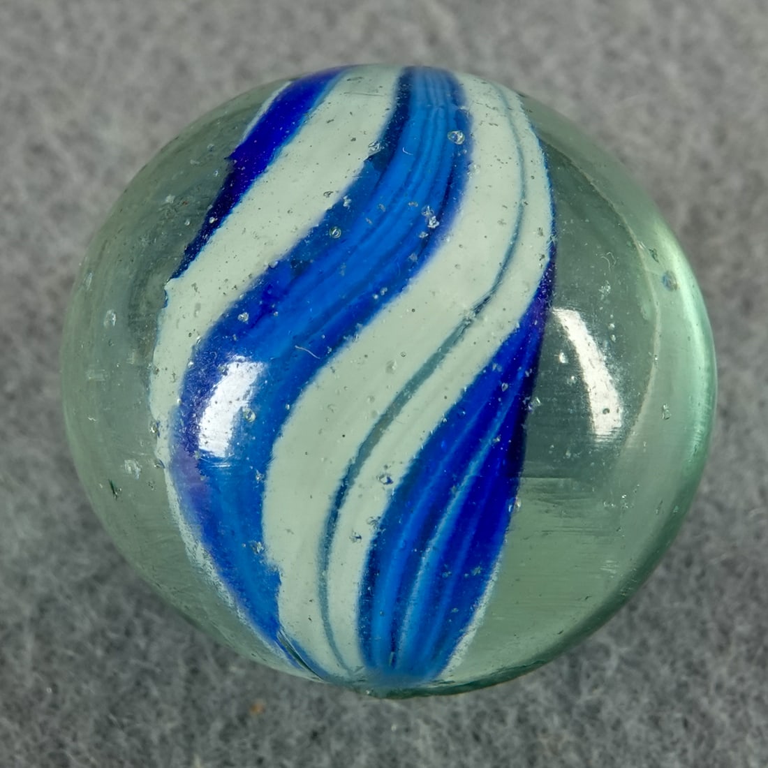 SWIRL, Solid Core. 1-1/16". Near Mint(+) (8.9).: SWIRL, Solid Core. Naked Solid Core Swirl. A little clear space between the panels. One very tiny flake. Germany, circa 1860-1920. 1-1/16". Near Mint(+) (8.9).