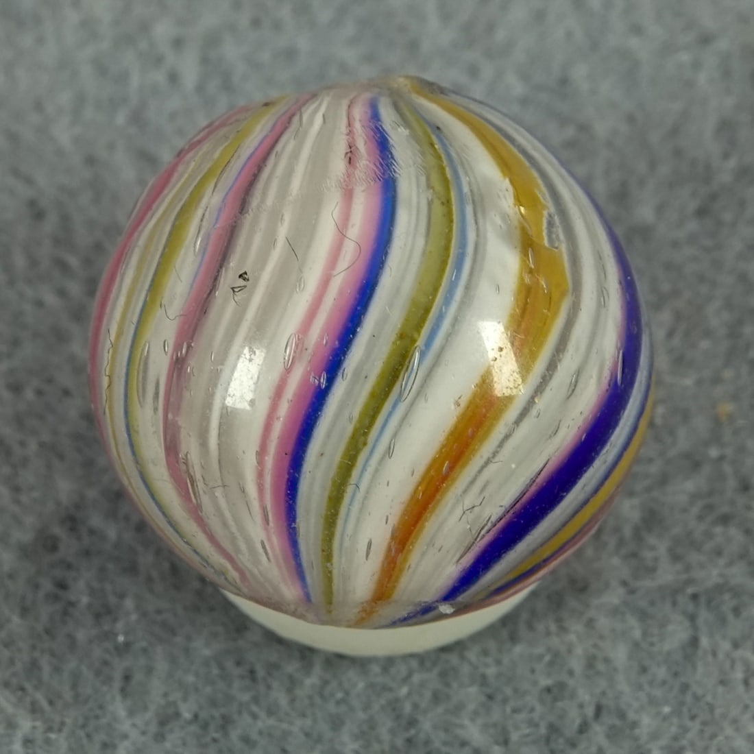 END OF DAY, Onionskin. 5/8". Mint(-) (9.0).: END OF DAY, Onionskin. Stretched pink, yellow, and blue on the white core. One tiny manufacturing melt pit. Germany, circa 1860-1920. 5/8". Mint(-) (9.0).