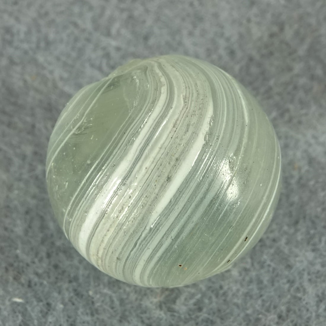 OTHER HANDMADE, Indian. Transparent. 11/16". Mint (9.8).: OTHER HANDMADE, Indian. Transparent Indian. Transparent clear base. Two panels of stretched white on the surface. Germany, circa 1860-1920. 11/16". Mint (9.8).