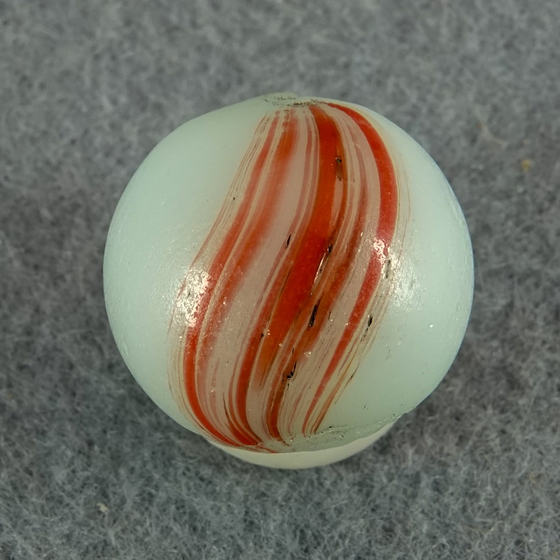 OTHER HANDMADE, Banded Opaque. 21/32". Mint(-) (9.0).: OTHER HANDMADE, Banded Opaque. Opaque white base. Two panels of stretched red on the surface. A little light pocket wear. Germany, circa 1860-1920. 21/32". Mint(-) (9.0).