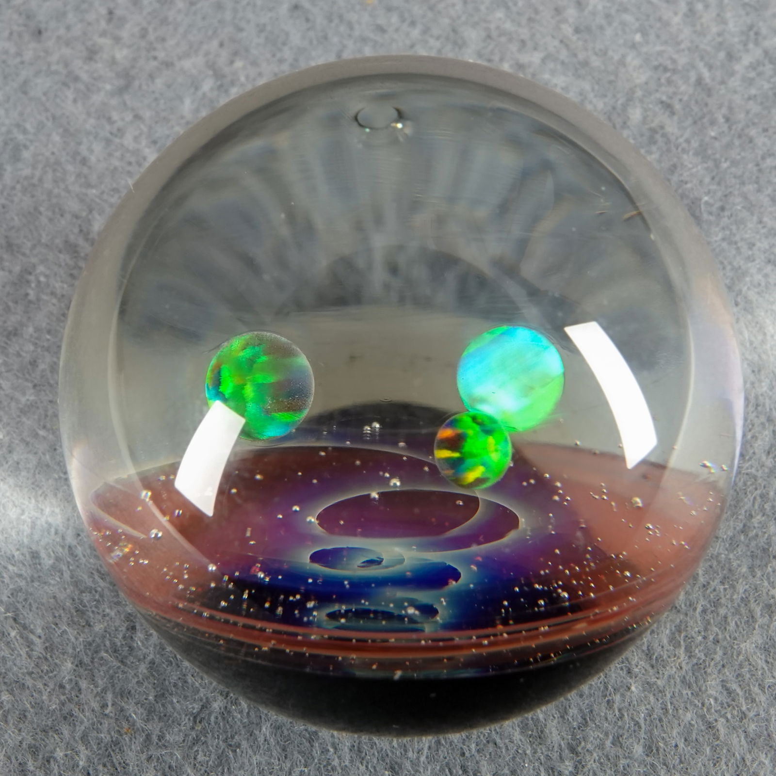 CONTEMPORARY HANDMADE, Signed "YU". 1-1/2". Mint (9.9).: CONTEMPORARY HANDMADE, YU. Shallow vortex nebula with three opal planets floating above it. Signed "YU 2022". Artist unidentified. 1-1/2". Mint (9.9).