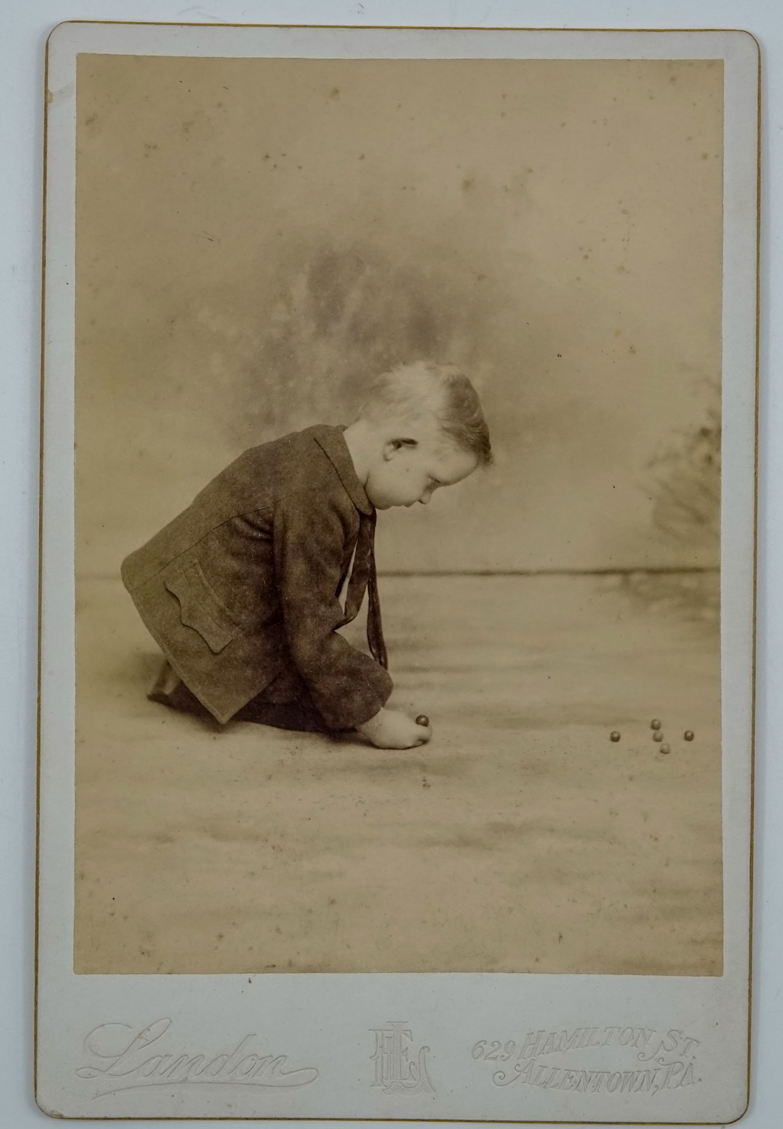 MISCELLANEOUS, Carte de Vista. Rare. Child shooting marbles.: MISCELLANEOUS, Carte de Vista. Rare photograph. This is an 1800s CDV of a boy shooting marbles. CDV's of children shooting marbles are very rare. Produced by Landon's of Allentown Pennsylvania. Second