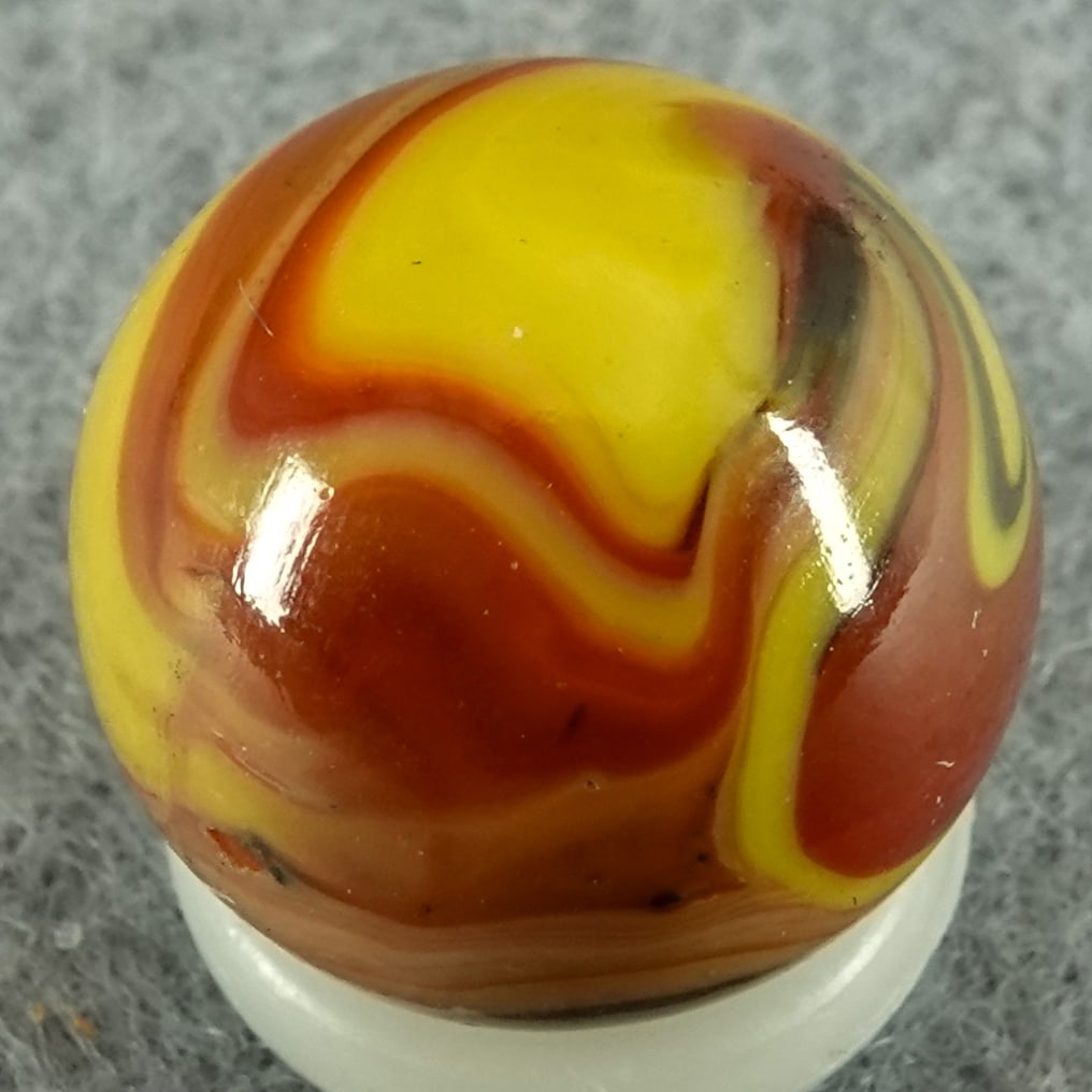 CHRISTENSEN AGATE COMPANY, Swirl. 9/16". Mint (9.9).: CHRISTENSEN AGATE COMPANY, Swirl. Two seam. Green, red and yellow swirls. Cambridge OH, circa 1925-1930. 9/16". Mint (9.9).