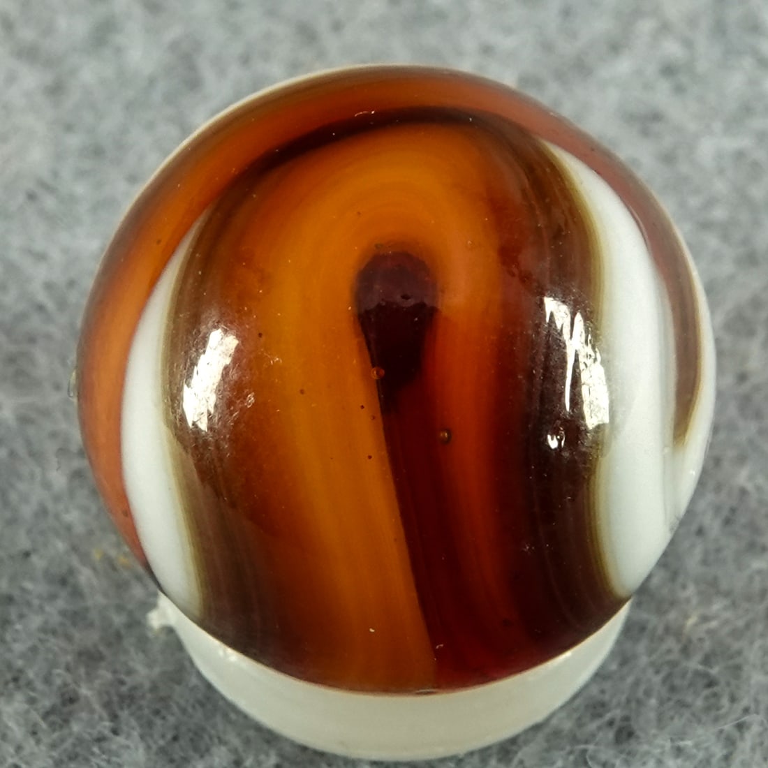 CHRISTENSEN AGATE COMPANY, Swirl. 5/8". Mint (9.9).: CHRISTENSEN AGATE COMPANY, Swirl. Opaque white swirls in transparent red. Cambridge OH, circa 1925-1930. 5/8". Mint (9.9).