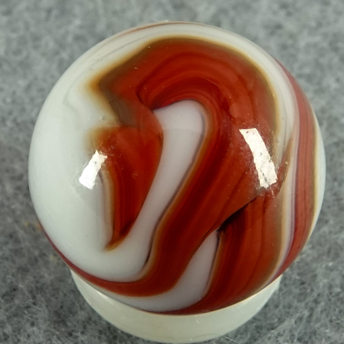 CHRISTENSEN AGATE COMPANY, Swirl. 5/8". Mint (9.9).: CHRISTENSEN AGATE COMPANY, Swirl. Red swirls in white Cambridge OH, circa 1925-1930. 5/8". Mint (9.9).