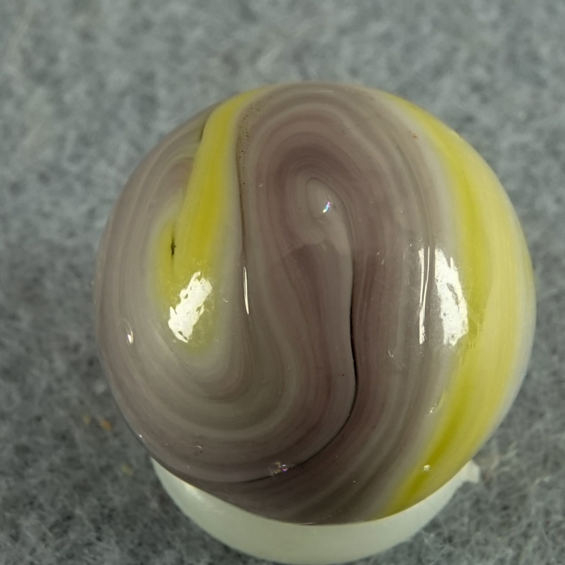 CHRISTENSEN AGATE COMPANY, Swirl. 5/8". Mint (9.9).: CHRISTENSEN AGATE COMPANY, Swirl. Yellow swirl in a mix of purple and white. Cambridge OH, circa 1925-1930 5/8". Mint (9.9).