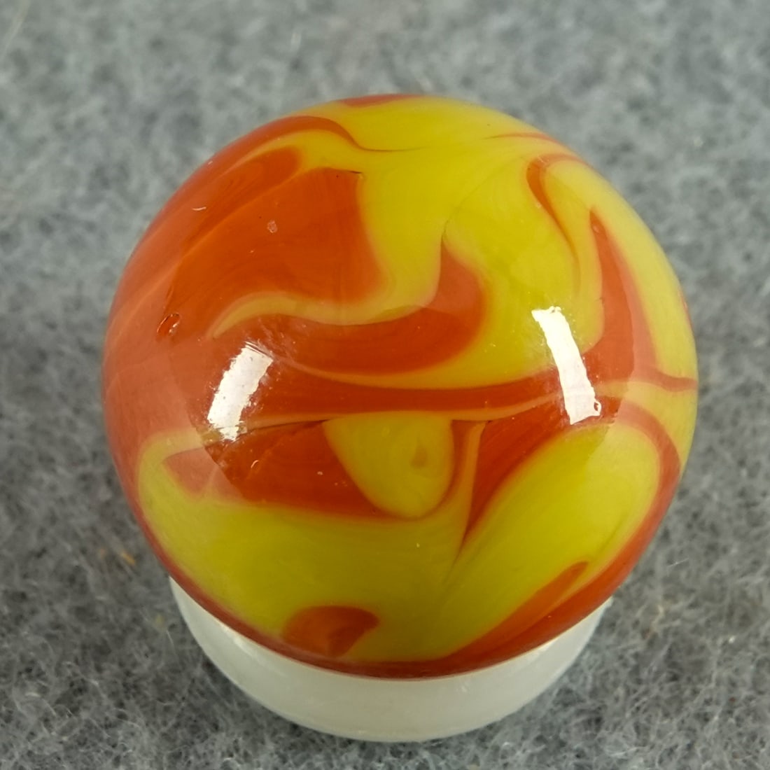 CHRISTENSEN AGATE COMPANY, Flame Swirl. 5/8". Mint (9.9).: CHRISTENSEN AGATE COMPANY, Flame Swirl. Orangish red flame swirls in yellow. Beauty. Cambridge OH, circa 1925-1930 5/8". Mint (9.9).