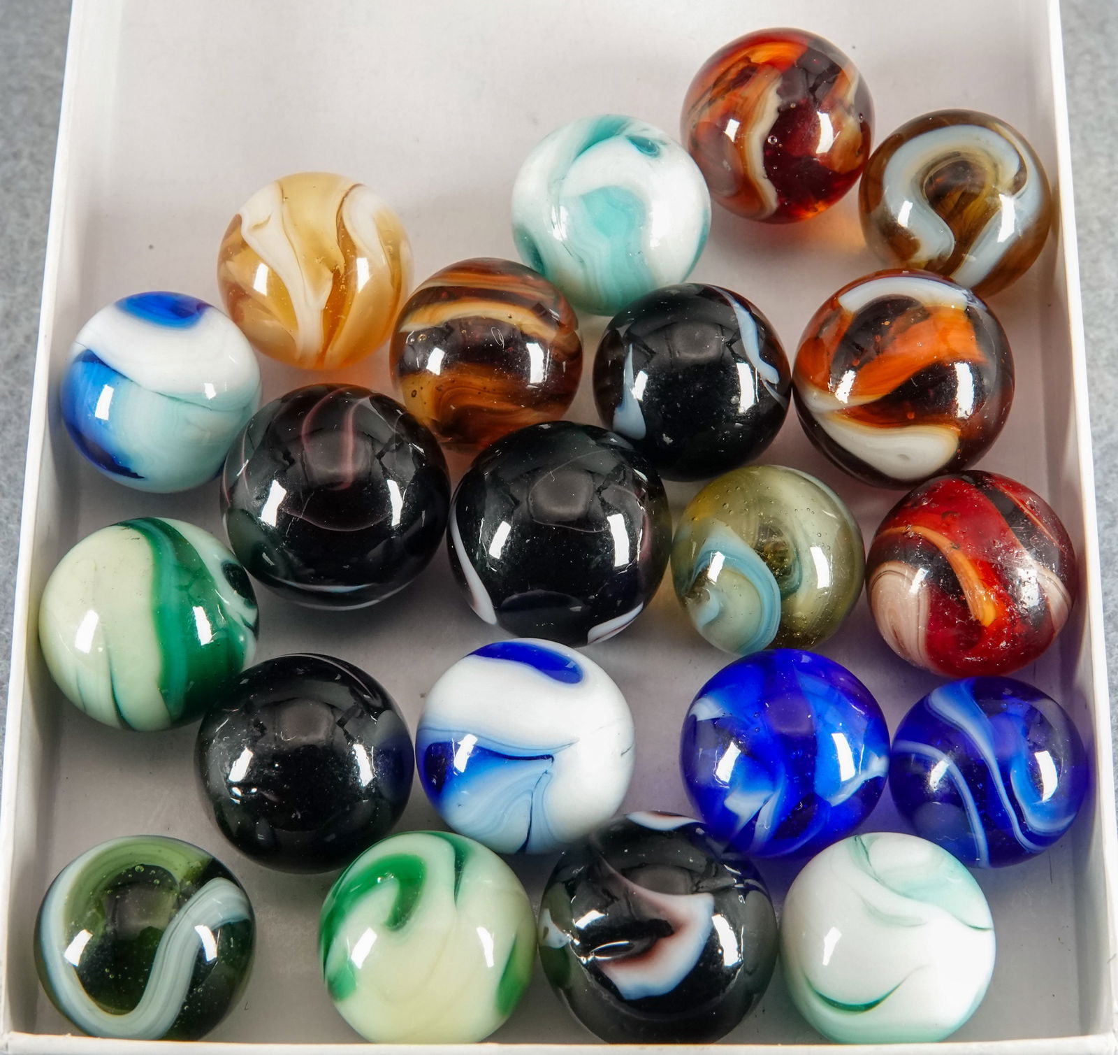 OTHER MACHINE MADE, Swirl. 21 marbles.: OTHER MACHINE MADE, Swirl. Lot of twenty-one marbles. Consignor had these in his case with the other Christensen Agate transparent swirls, but we feel most, if not all, are not Christensen Agate. See