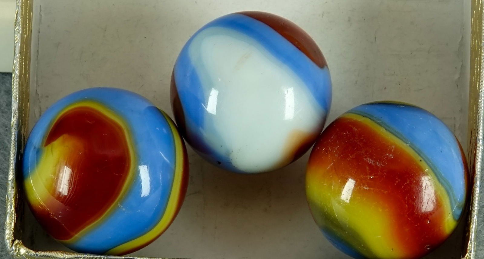 AKRO AGATE COMPANY, Corkscrew. 3 marbles. 2 are Mint.: AKRO AGATE COMPANY, Corkscrew. Lot of three marbles. Variety of colors. All are three-color. Shooters. See images. Clarksburg WV, circa 1925-1935. All 13/16". Two are Mint, one has dirt from being und