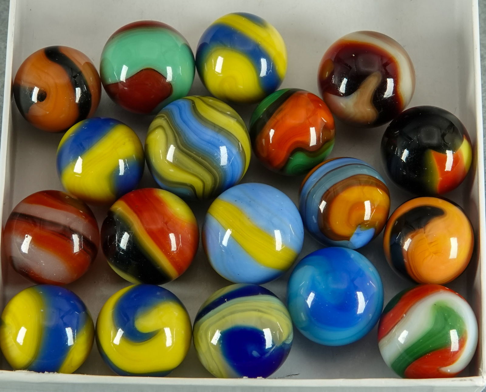 AKRO AGATE COMPANY, Corkscrew. 18 marbles. Mint.: AKRO AGATE COMPANY, Corkscrew. Lot of eighteen marbles. Variety of colors. See images. Clarksburg WV, circa 1925-1935. 5/8" to 23/32". Mint.