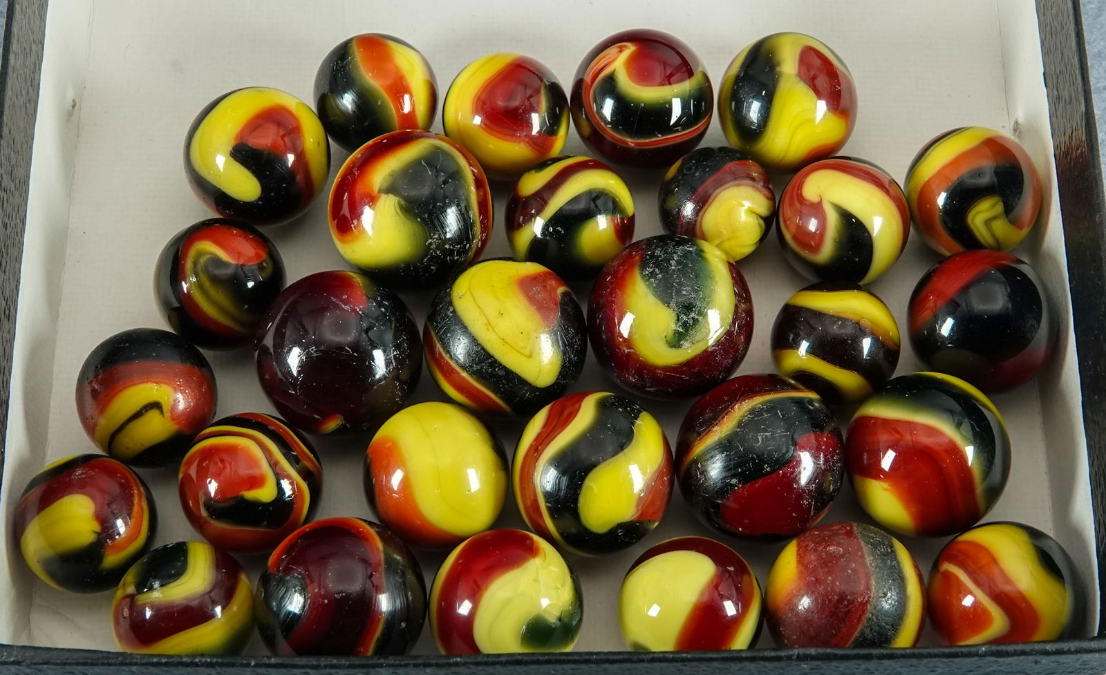 AKRO AGATE COMPANY, Corkscrew. 28 marbles.: AKRO AGATE COMPANY, Corkscrew. Lot of twenty eight marbles. All are three-color Indian Blanket Corkscrews. These are all dug marbles. Either not Mint or have been buffed. See images. Clarksburg WV, ci