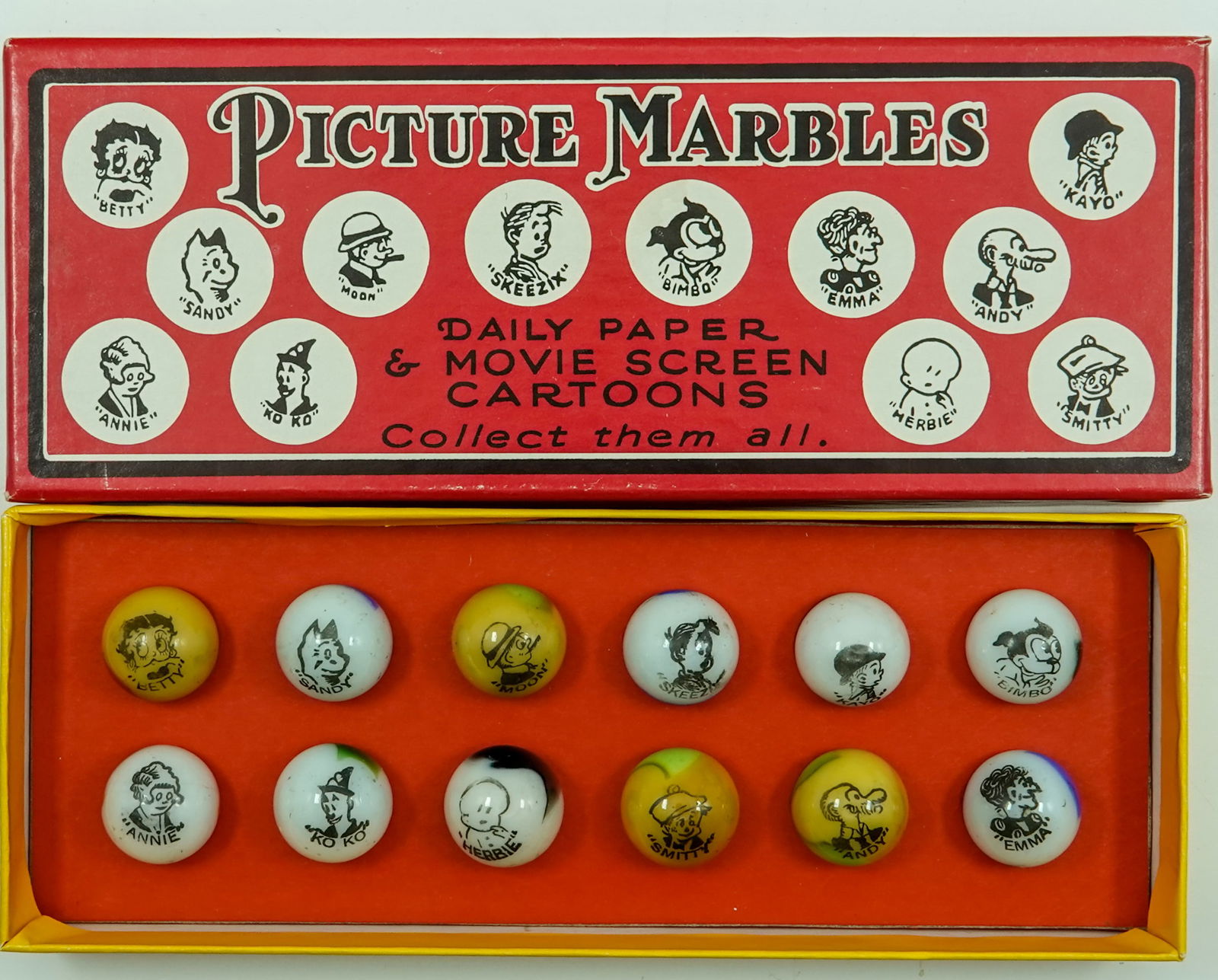 PELTIER GLASS COMPANY, Original Package. 12 original Comics in reproduction box.: PELTIER GLASS COMPANY, Original Package. A set of twelve Peltier Comic marbles in reproduction box. Complete set of characters. Box is stamped inside as a reproduction and is numbered 92. Marbles are