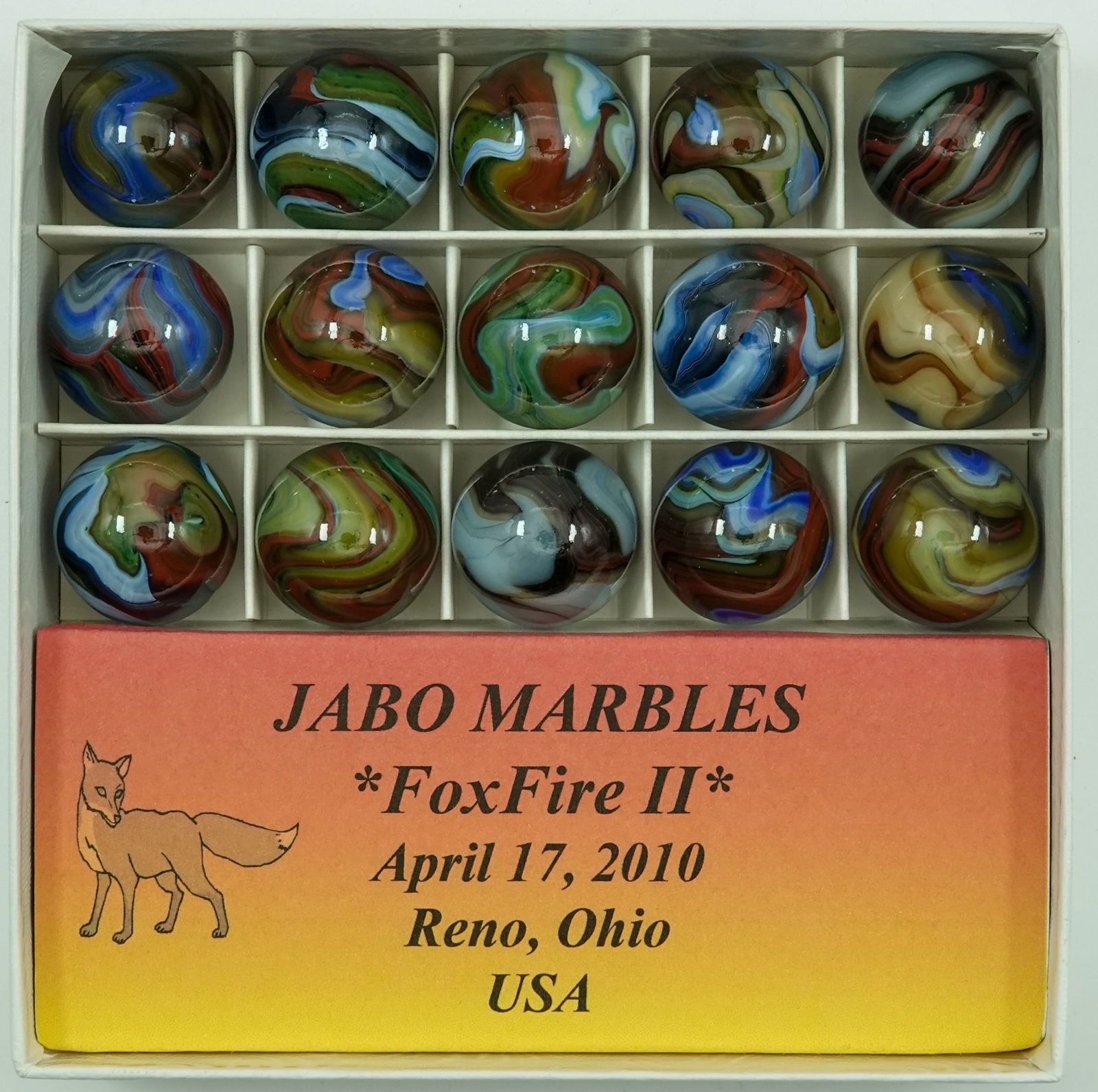 JABO/SAMMY/DAS, Jobber Box. Jabo Foxfire II.: JABO/SAMMY/DAS, Jobber Box. Cardboard display box containing fifteen marbles. Jabo Foxfire II run date April 17, 2010. 23/32". Mint.