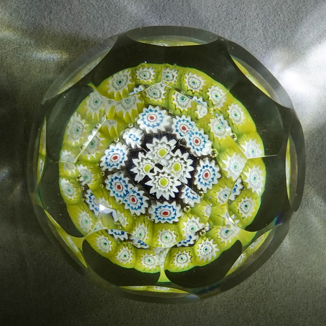 PAPERWEIGHT, Murano.: PAPERWEIGHT, Murano. Concentric ring on lutz base. Faceted. Unsigned. We are not sure which glass house it is from in Murano. Italian, circa 1970-1990. 2-3/8" wide, 2-1/8" tall .