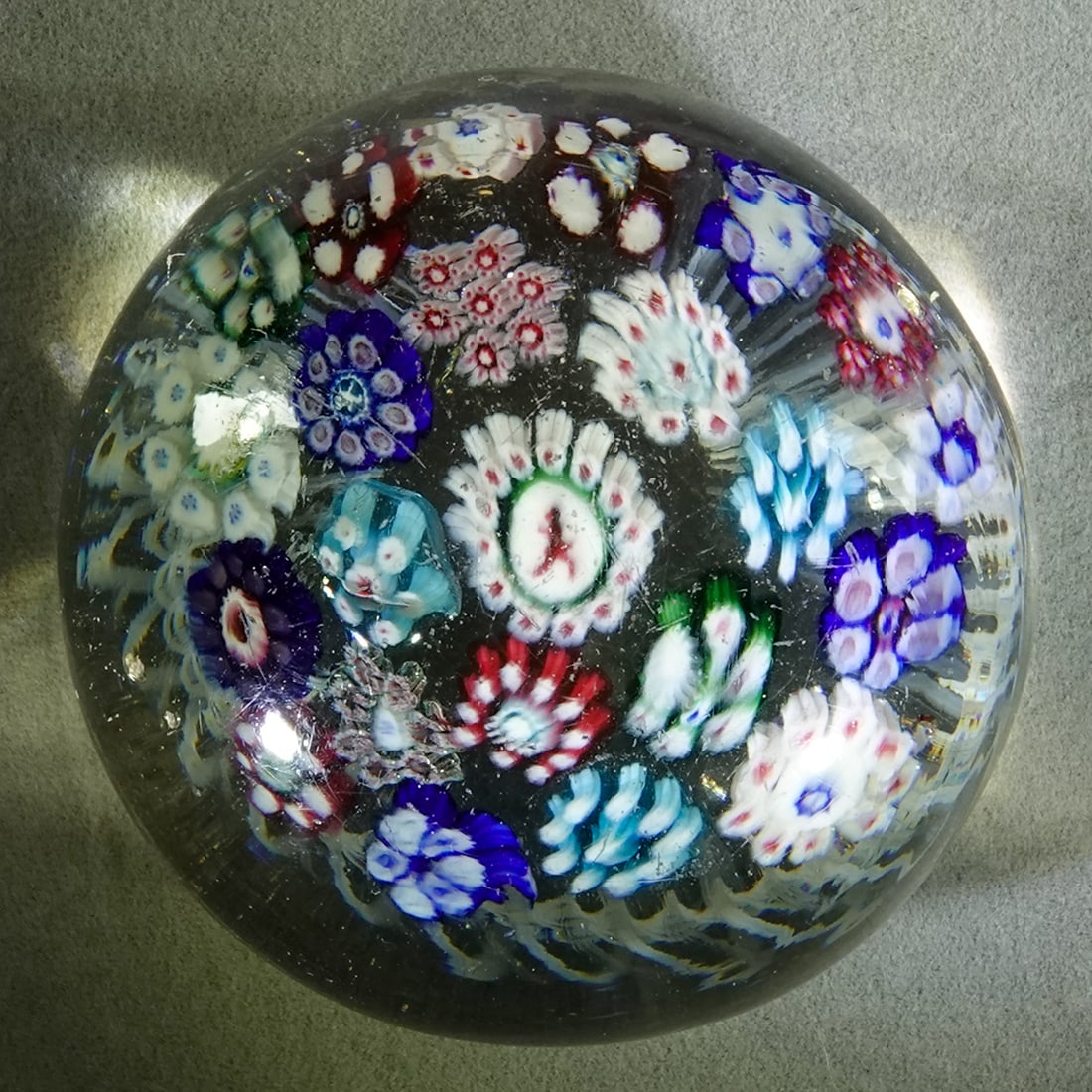 PAPERWEIGHT, Josephinehutte. Antique. Silesian.: PAPERWEIGHT, Josephinehutte. Concentric ring millefiori canes. Dancing Red Devil silhouette cane in the center. Small lattice base. Two tiny chips about halfway down the side of the marble. Tiny pit