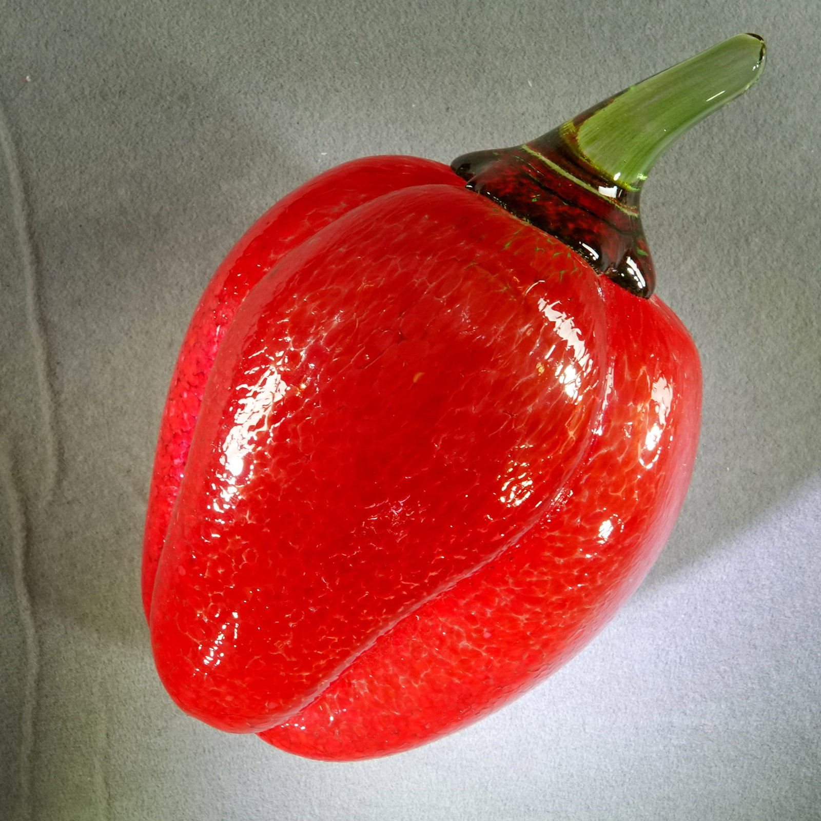 PAPERWEIGHT, Kosta Boda.: PAPERWEIGHT, Kosta Boda. Red Pepper. Signed Kosta Boda and dated 05. Other illegible writing with the signature. 3" wide, 4-3/4" long .