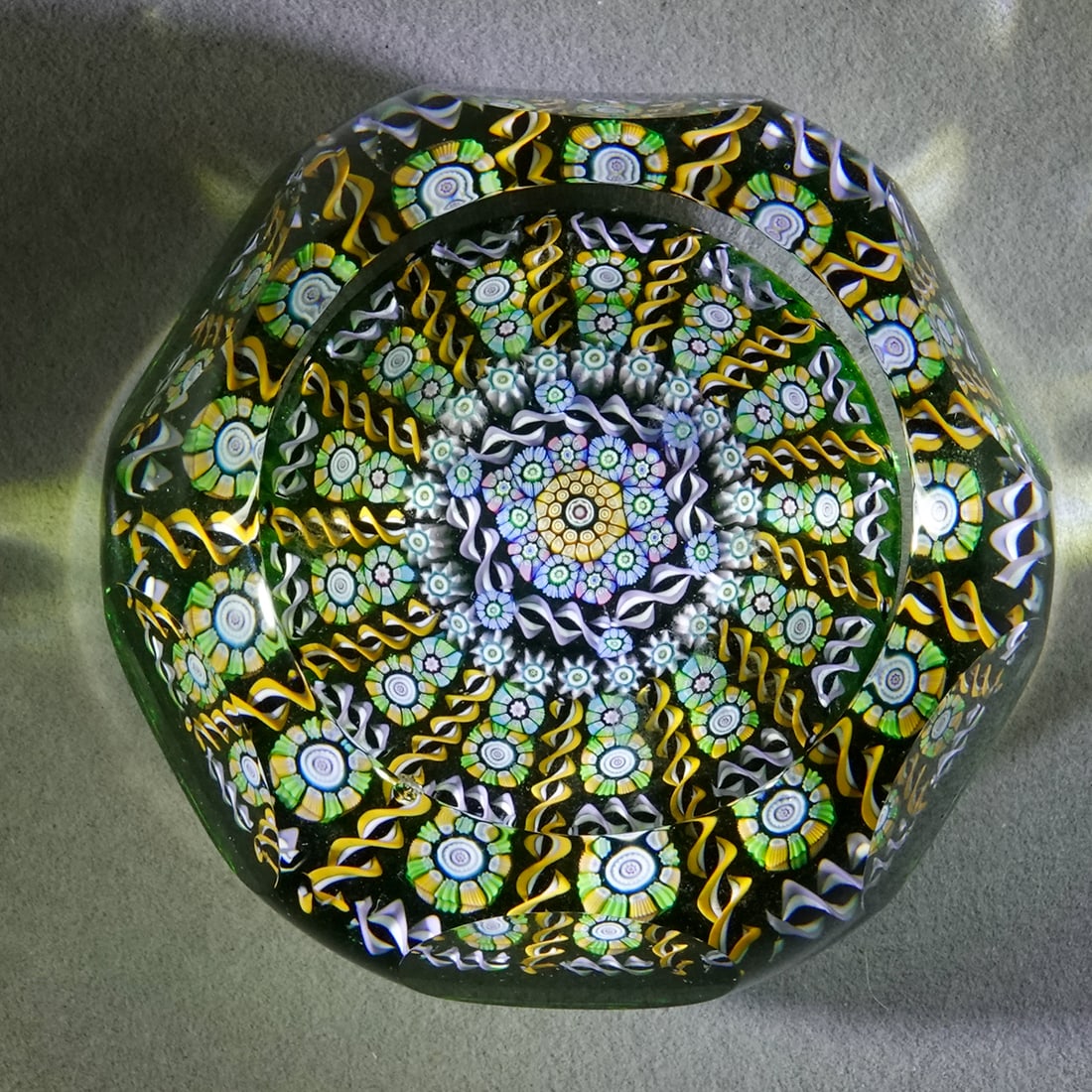 PAPERWEIGHT, Perthshire Paperweights.: PAPERWEIGHT, Perthshire Paperweights. Limited Edition paperweight. Complex pattern. Faceting with a top window. Has a "P 1994" date cane in the bottom. Scratch numbered 95 on the bottom. 3" wide,