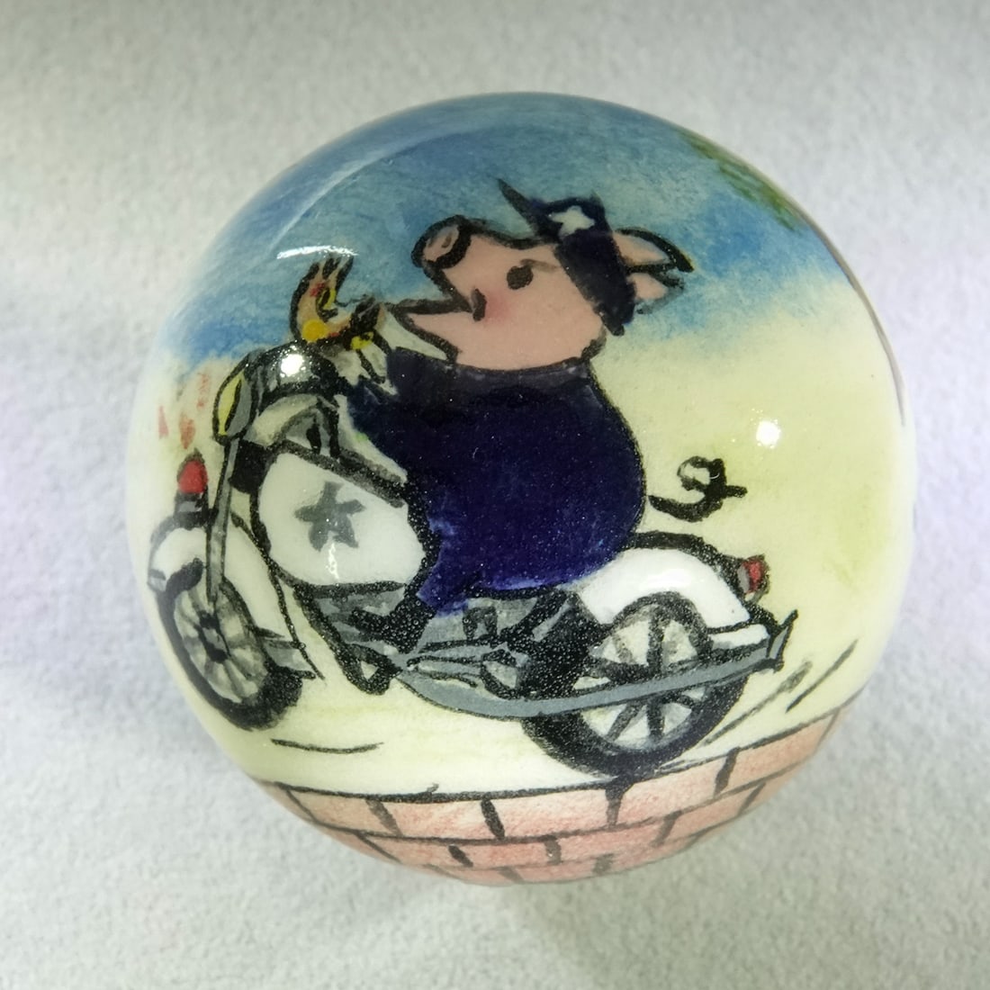 CONTEMPORARY HANDMADE, Gregg Pessman. 1-7/16". Mint (9.9).: CONTEMPORARY HANDMADE, Gregg Pessman. One of the Pigs at Play series. Handmade and handpainted China. Pig on a police motorcycle chasing another motorcyclist. Signed "GP 2020". Accompanied by a