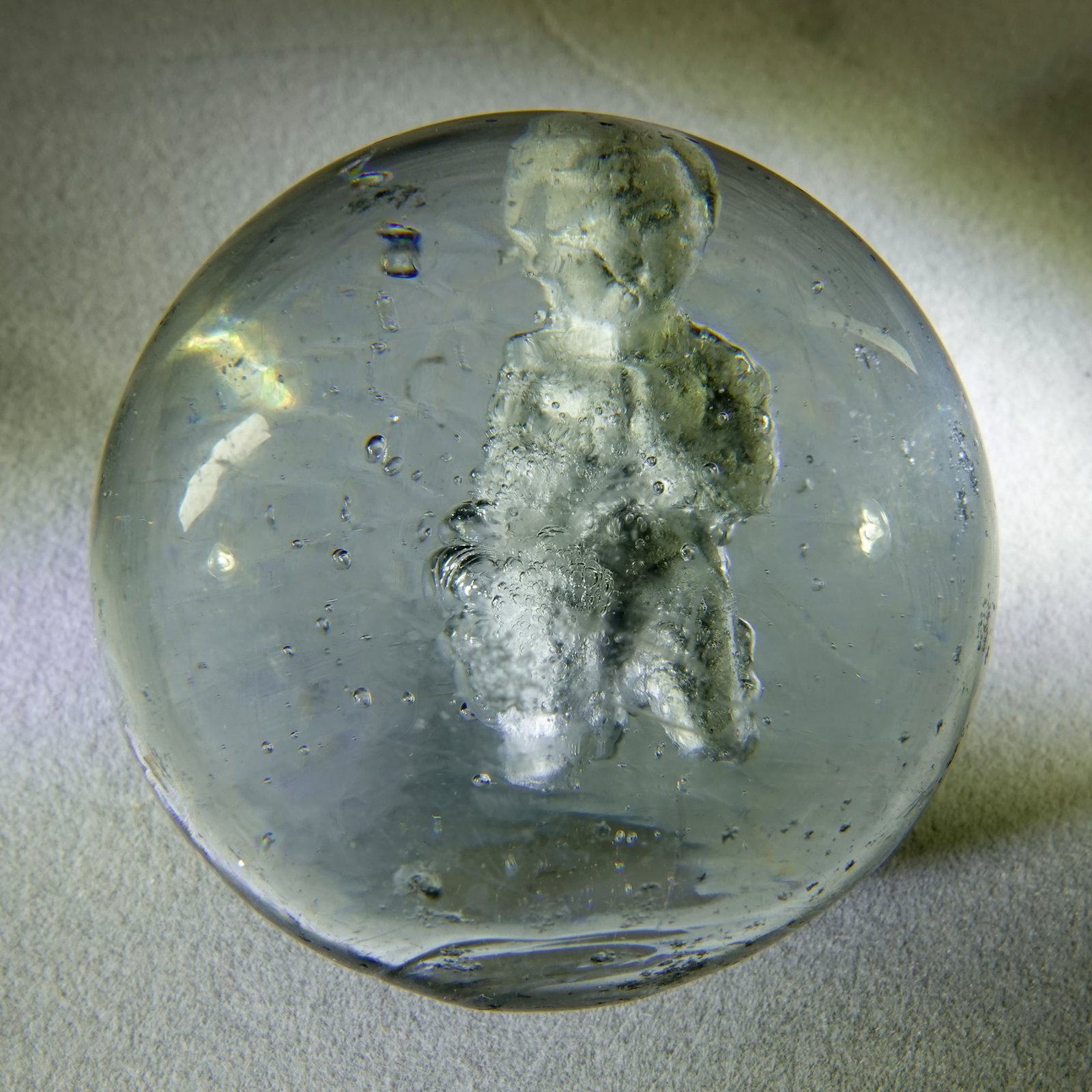 SULPHIDE. Praying Child. 1-7/8". Near Mint (8.3).: SULPHIDE.Figure is a Praying Child. Naked child kneeling in prayer. Excellent detail to the figure. Set a little high in the marble. Some very small air bubbles on the right side of the figure, but