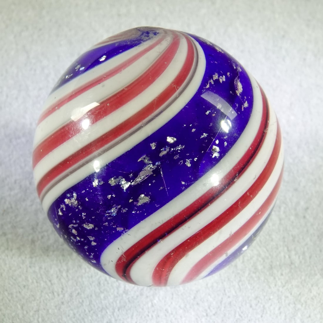SWIRL, Peppermint with Mica. 1-1/16". Buffed .: SWIRL, Peppermint. Larger Peppermint with Mica. Six pink bands. Heavy mica in the blue bands. Surface has been buffed, pontils are intact. Germany, circa 1860-1920. 1-1/16". Buffed .