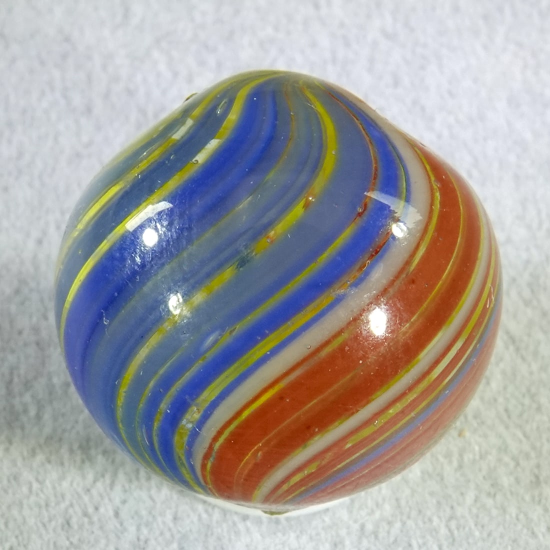SWIRL, Joseph Coat. 3/4". Mint(-) (9.0).: SWIRL, Joseph Coat. Rare Three-Panel Joseph Coat. Clear base. Three panels of stretched electric color bands. One is red, one is blue, one is yellow. Two manufacturing dimples at the top. Germany,