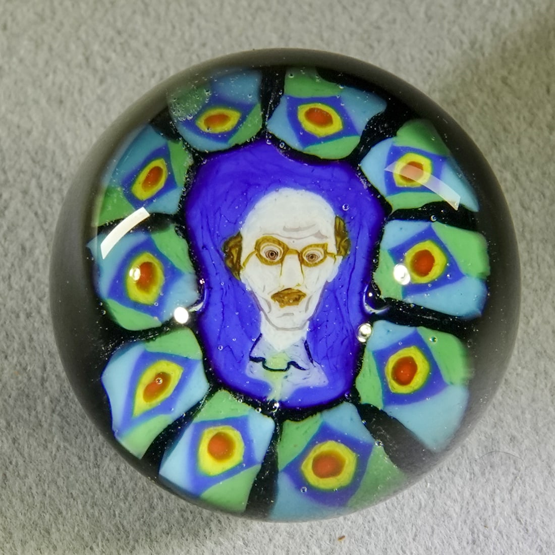 CONTEMPORARY HANDMADE, Dinah Hulet. 31/32". Mint (9.9).: CONTEMPORARY HANDMADE, Dinah Hulet. Bust of a bald man viewed through a top lens. Temari style. Signed "hulet/97". 31/32". Mint (9.9).