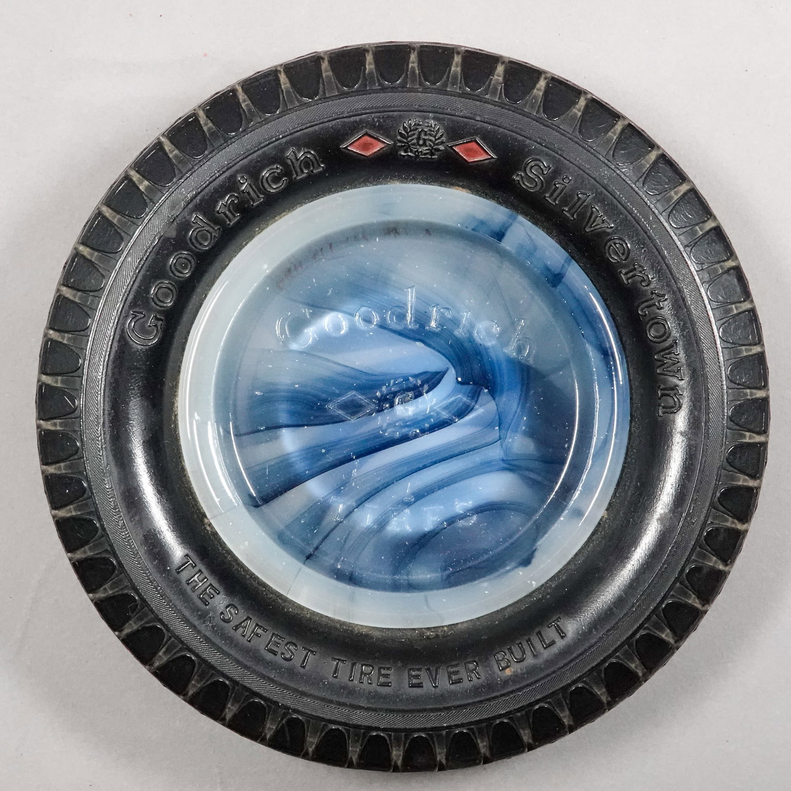 AKRO AGATE COMPANY, Advertising. Goodrich Tires. Akroware.: AKRO AGATE COMPANY, Advertising. Advertising item made for Goodrich Tires. A black and white Akroware ashtray embossed with the Goodrich logo. Surrounded by a replica rubber Goodrich tire. Circa